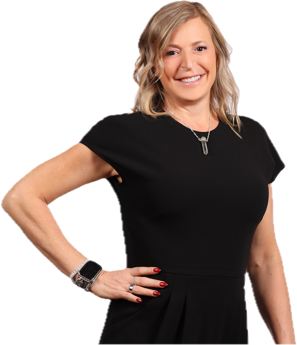 A woman with blonde hair, wearing a black dress, smiling, with her left hand on her hip, standing against a white background.