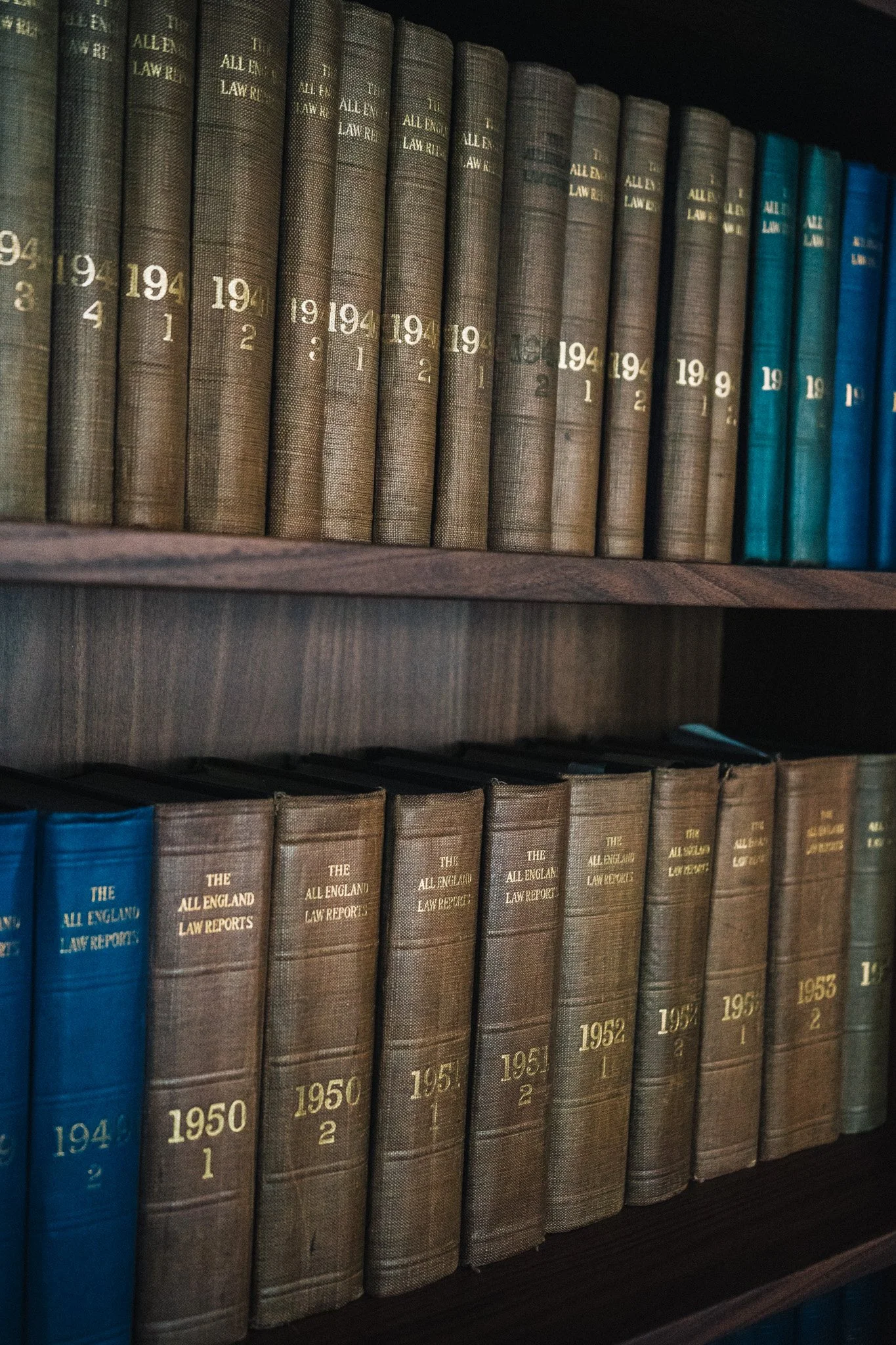 Shelf of law books, including volumes of 'The All England Law Reports' spanning from 1949 to 1953.
