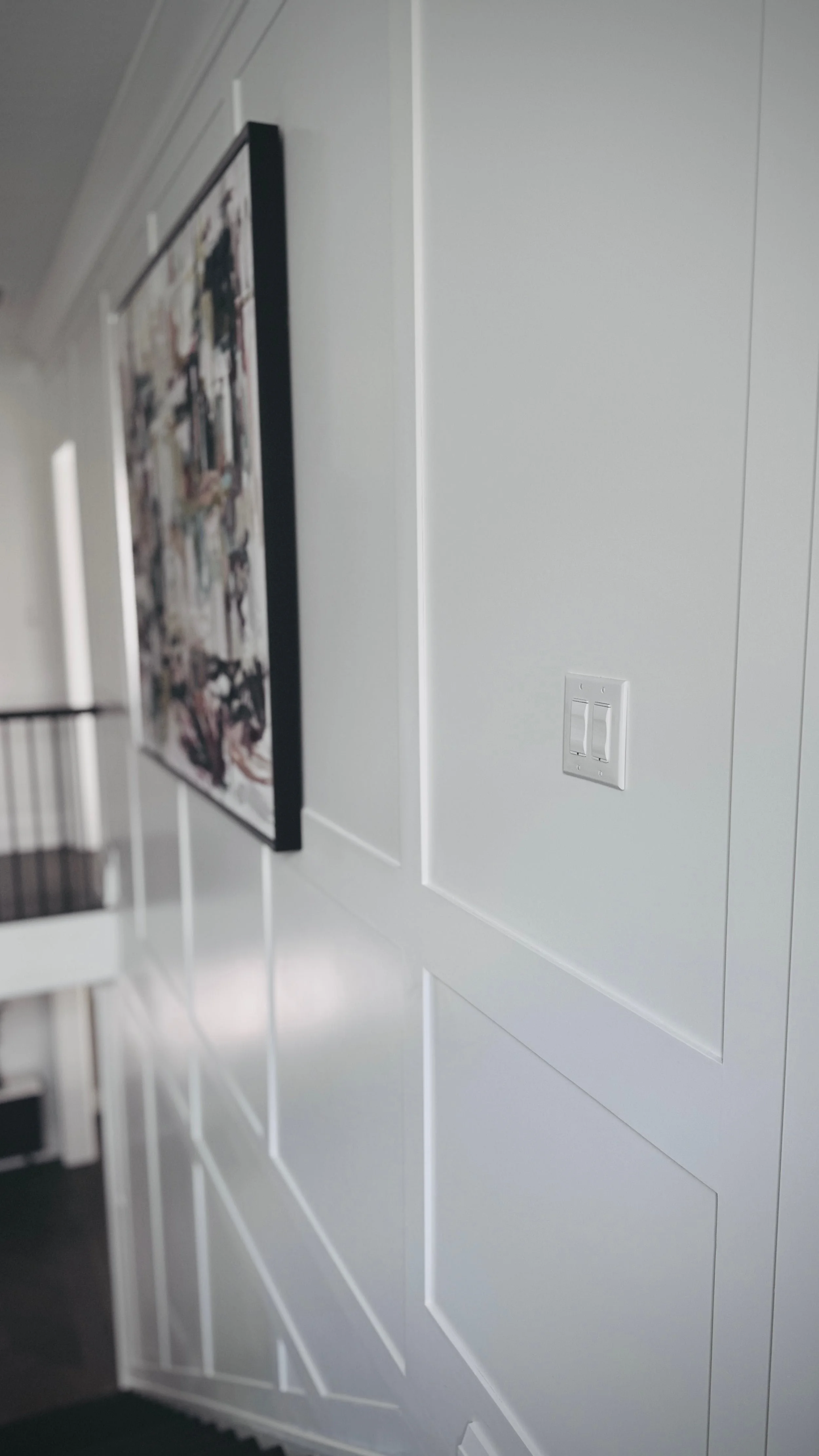 Smart light switch with an art frame in the background