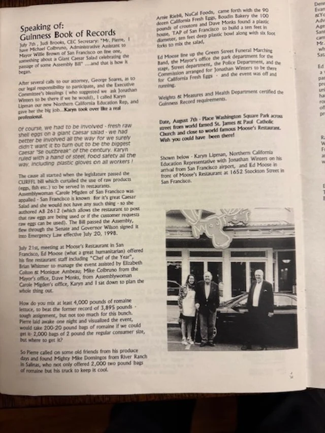 A newspaper clipping featuring a story about the Guinness Book of Records, including a photograph of five individuals standing outside a building with a car in front.