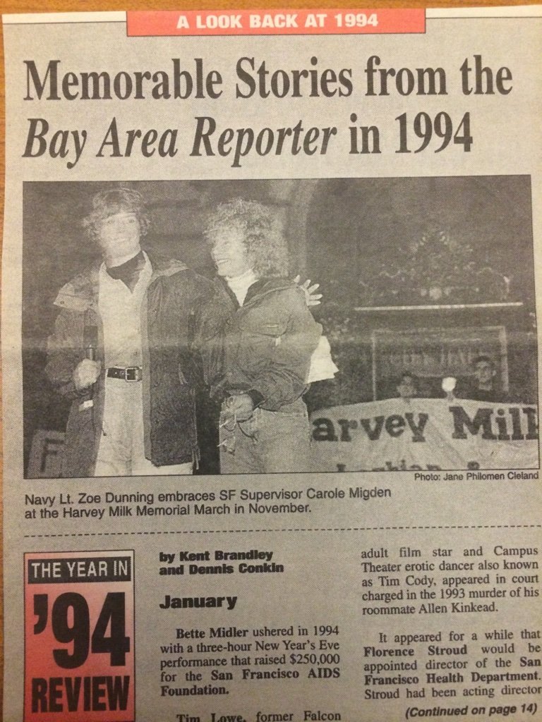 Newspaper clipping from 1994 showing Navy Lt. Zoe Dunning with Carole Migden at the Harvey Milk Memorial March, with a sign for Harvey Milk in the background.