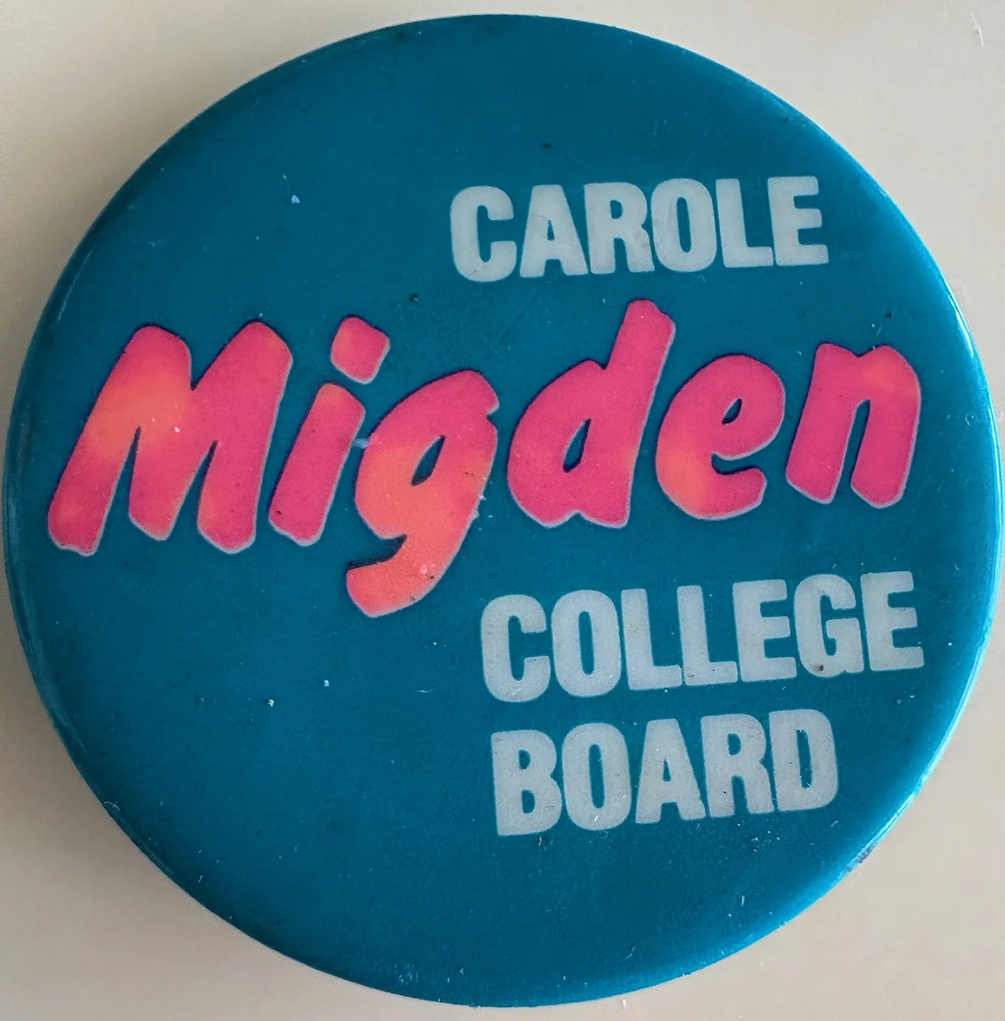 Blue campaign button with pink and white text reading, 'Carole Mijden College Board'.