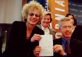 Carole Migden and Governor Gray Davis sign the Domestic Partnership Bill