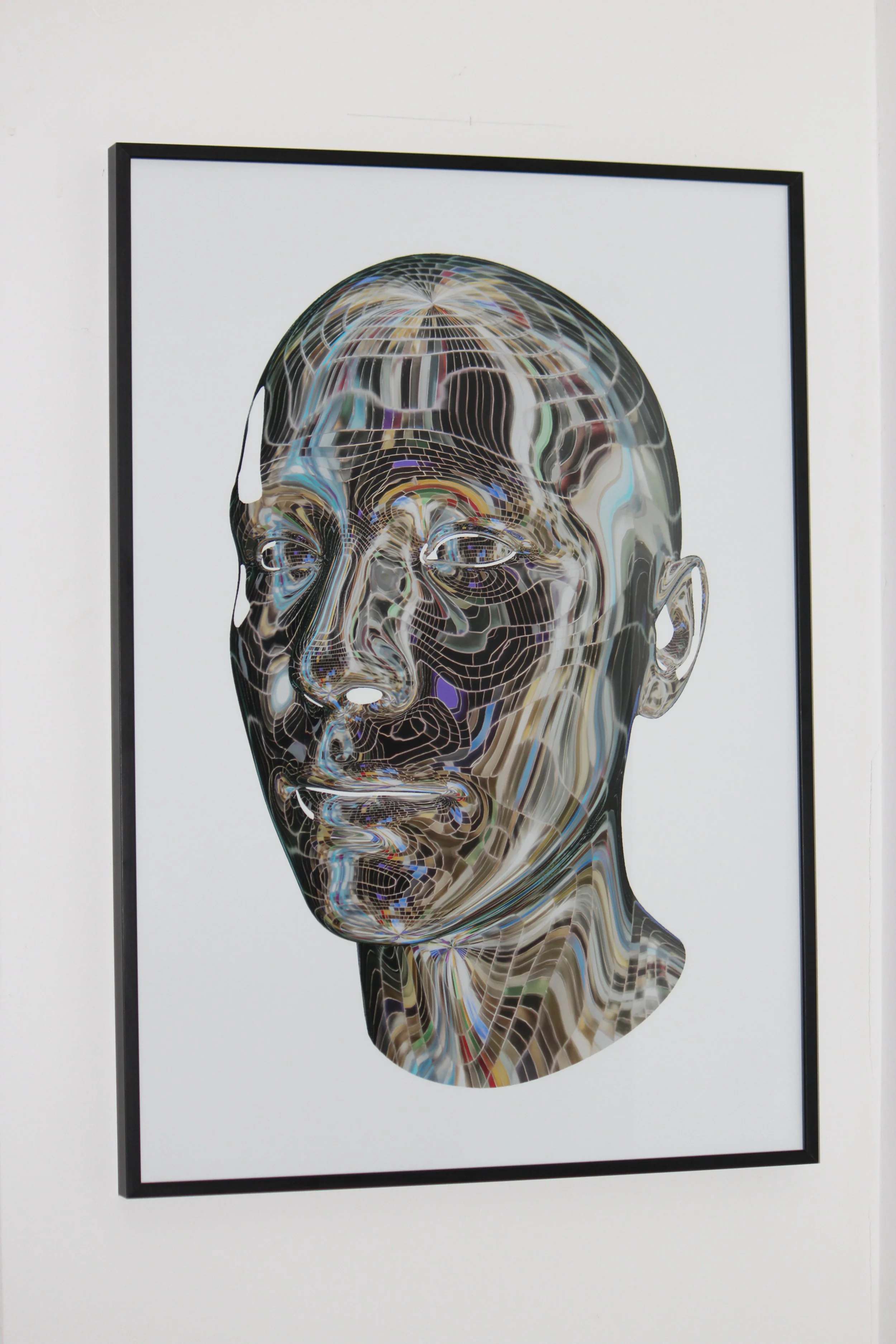 Framed art print of a male head made out of silver disco ball pieces on a white background.