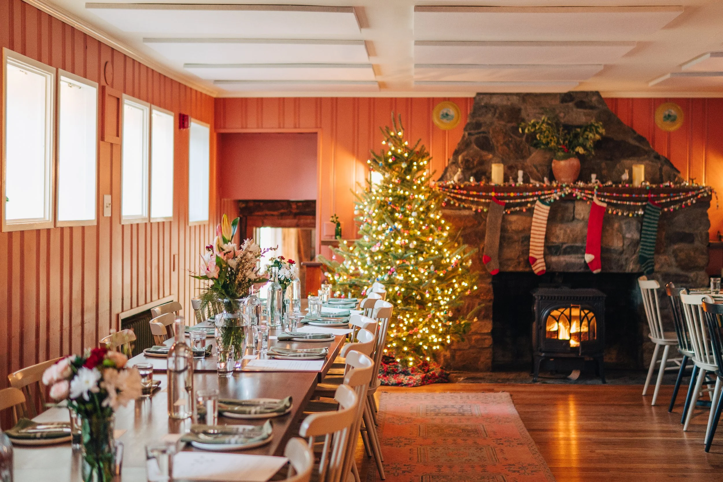 A December wedding in the library looking festive with a tree and stockings on the mantel.