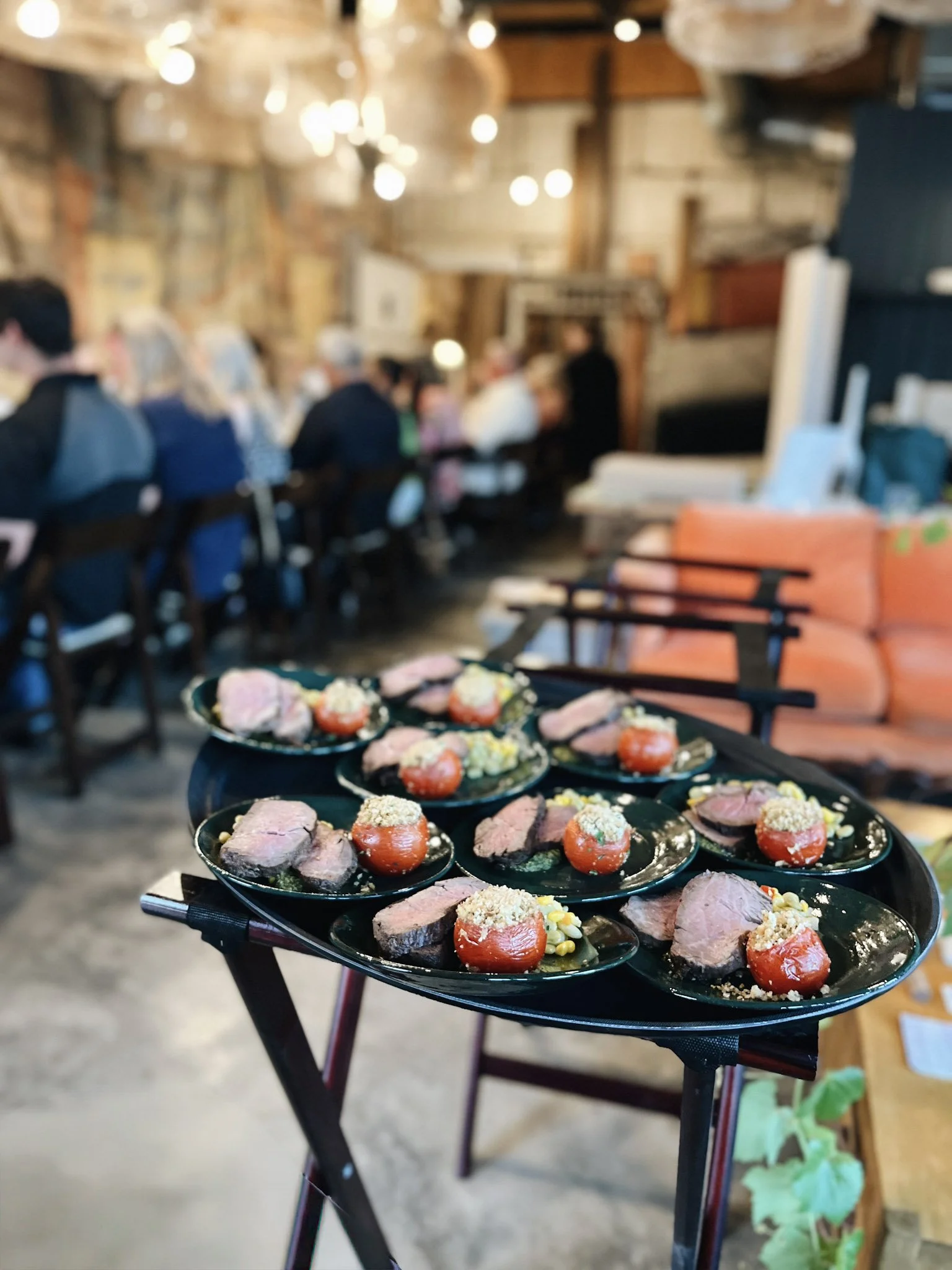Local green ceramic dishes plated for service under lantern light/