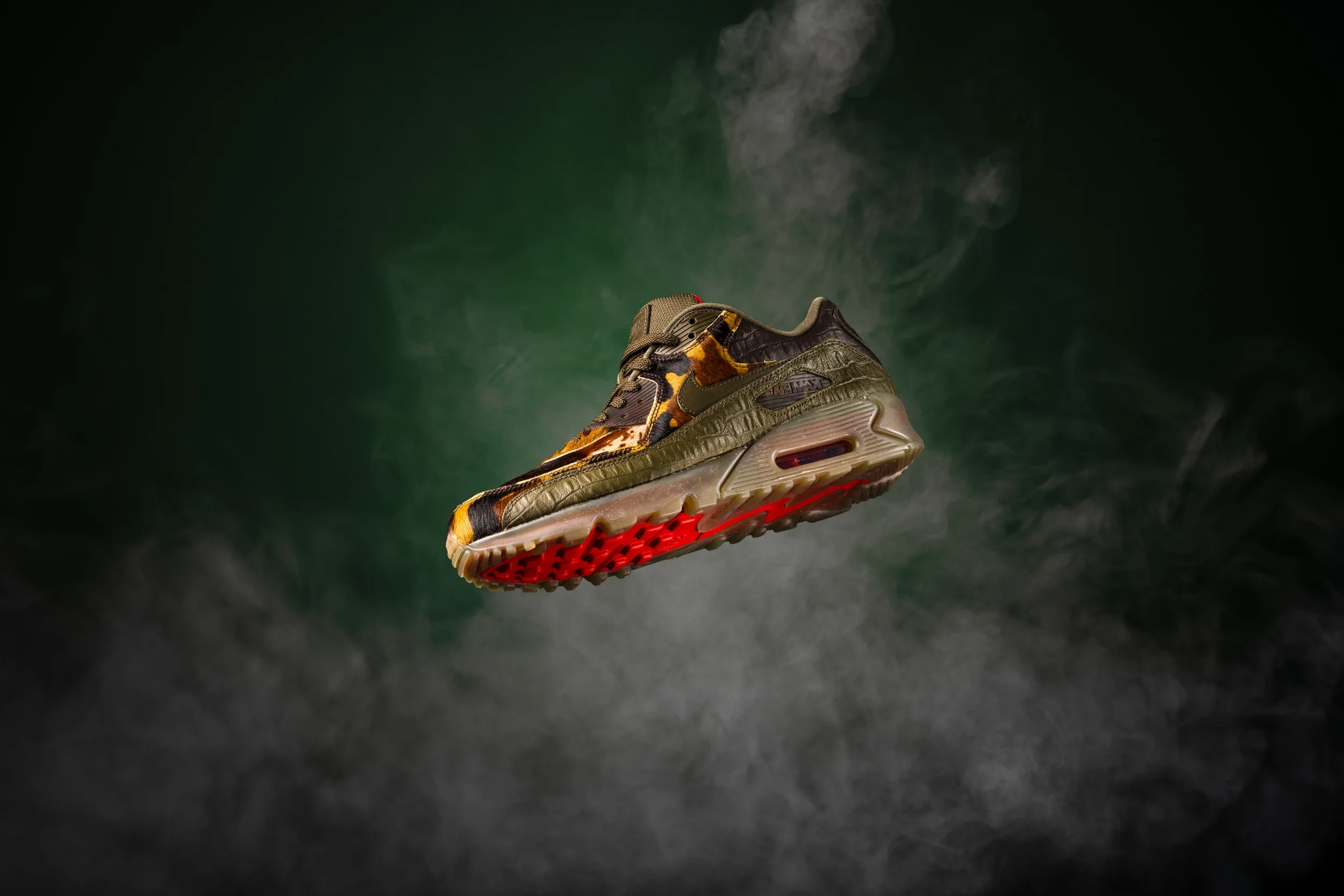 commercial product photography studio image of a sneaker with camouflage and animal print details, floating in mid-air on a dark green background and smoke.