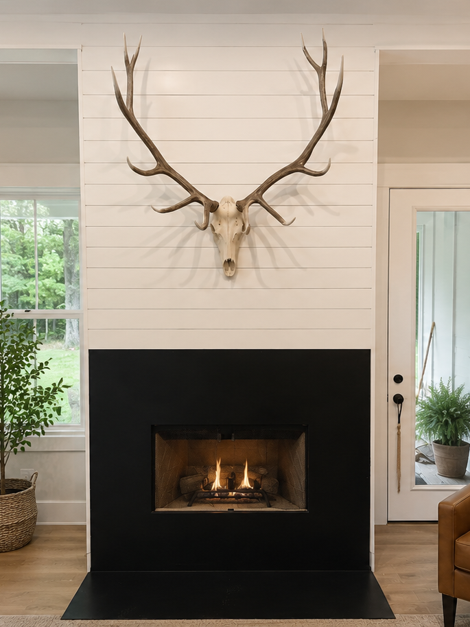 This fireplace project created a warm, modern focal point with a custom shiplap feature wall and a clean black fireplace surround. 