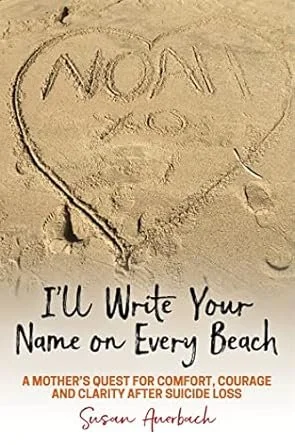 A heart drawn in the sand with the words "NOON" and "LOVE" inside, and a book cover titled "I'll Write Your Name on Every Beach" by Susan Amberbach, about coping with suicide loss.