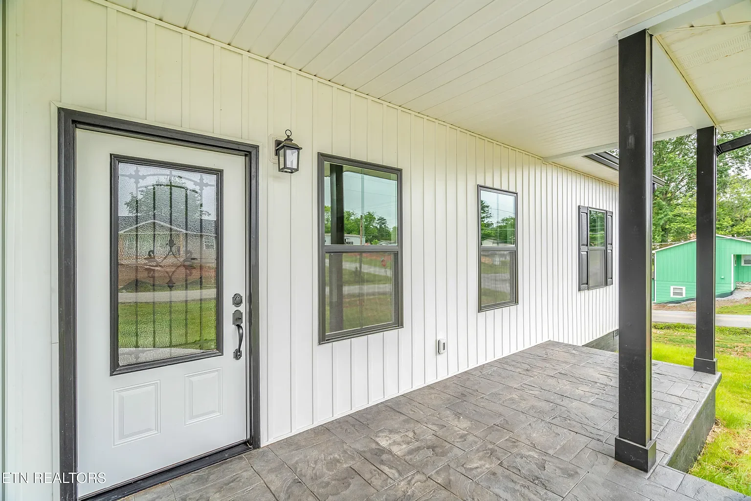 Installed vinyl siding and soffit around porch.