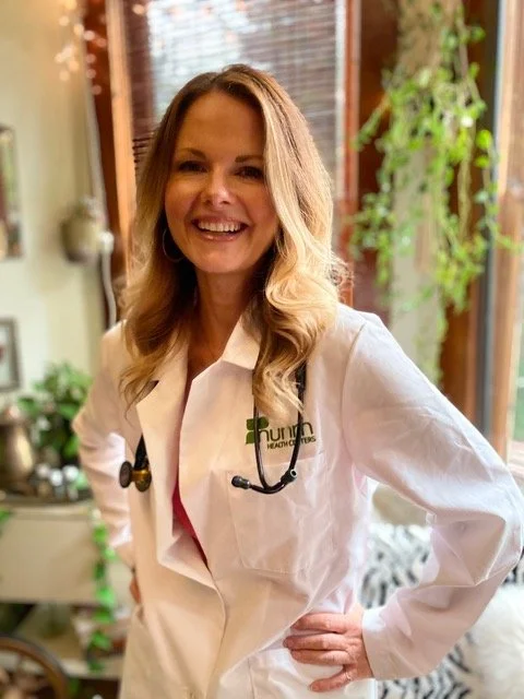 Raechelle looking joyful in her white doctors coat while completing her masters in nutrition.