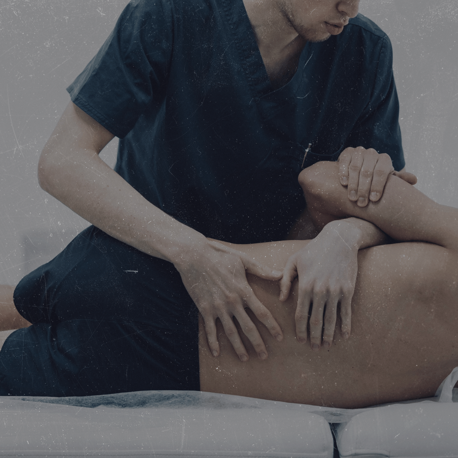A healthcare professional performing a massage on a patient's leg.