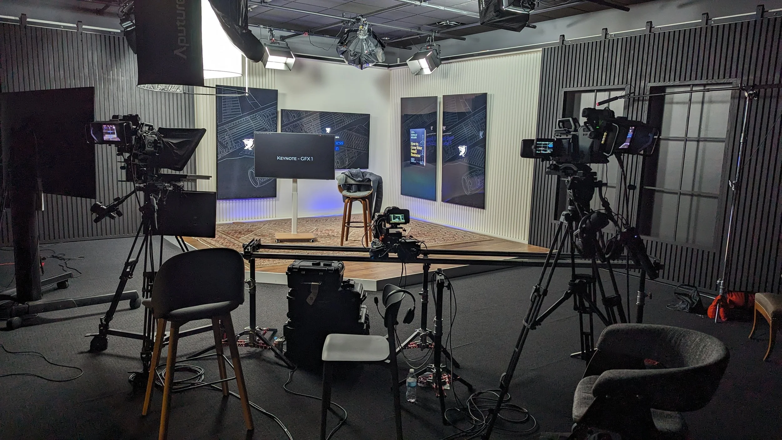 A professional video studio setup with cameras, lighting, and a backdrop for filming a presentation or interview in the new Donald Miller studio.