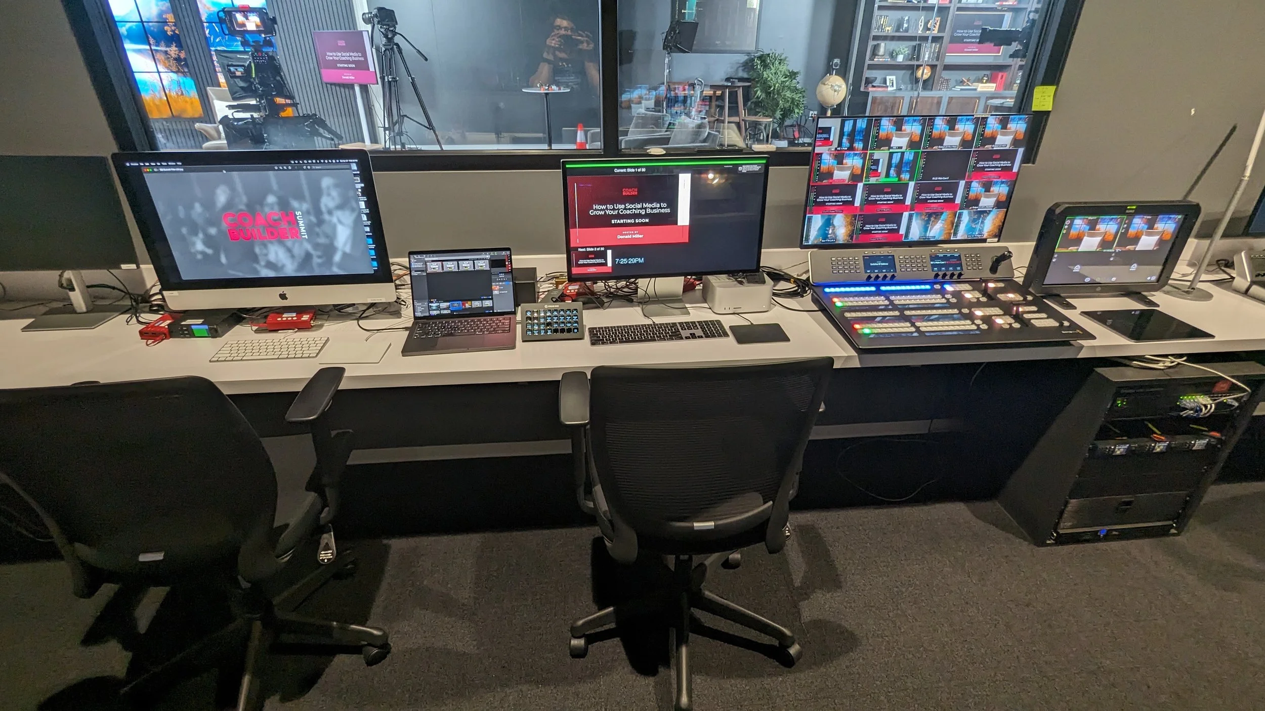Video production control room with multiple monitors, control panels, keyboards, mice, and chairs facing the equipment.