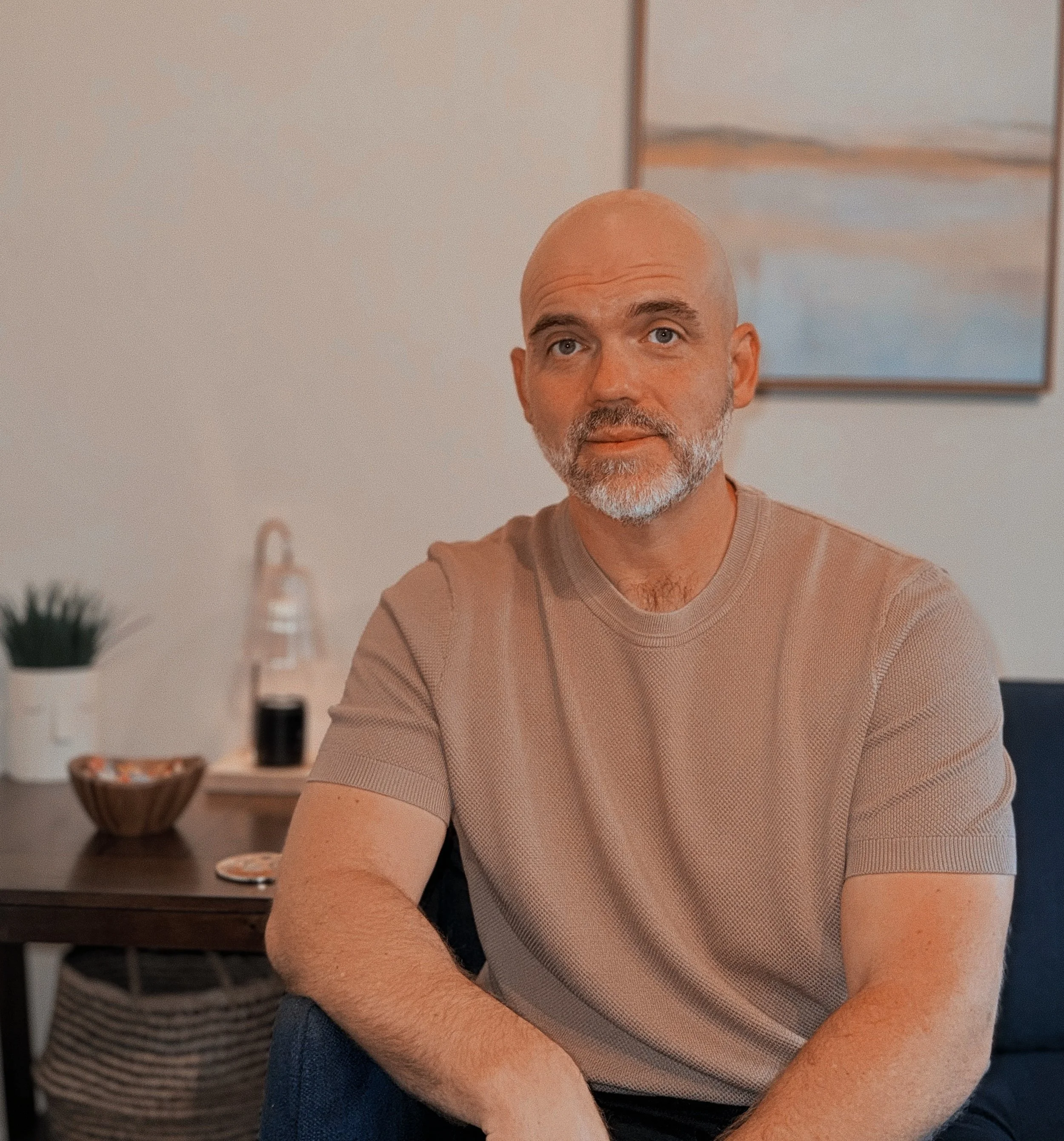 Ben Esch, LMFT, sitting on the couch in his San Marino, CA therapy office.