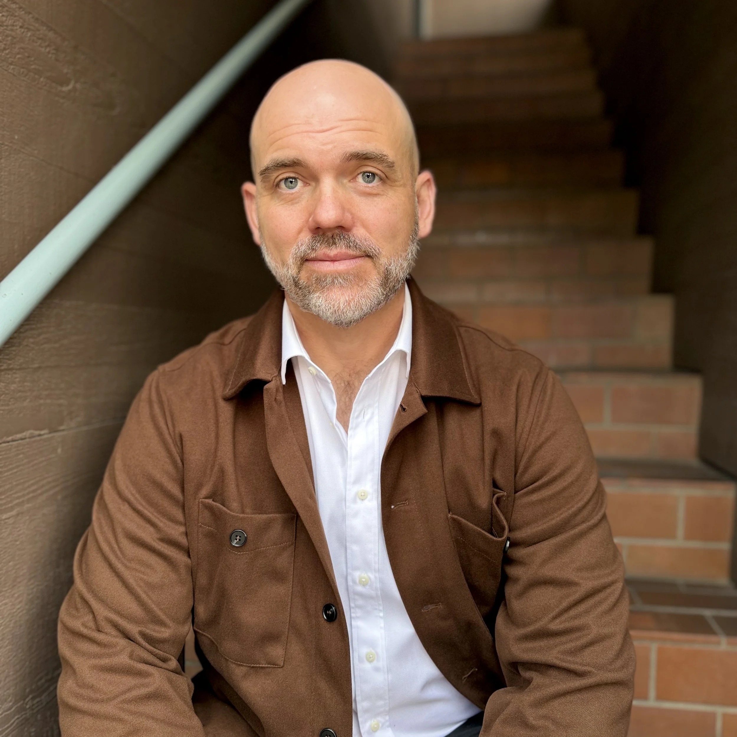 Ben Esch, LMFT, sitting on the stairs outside of his office.