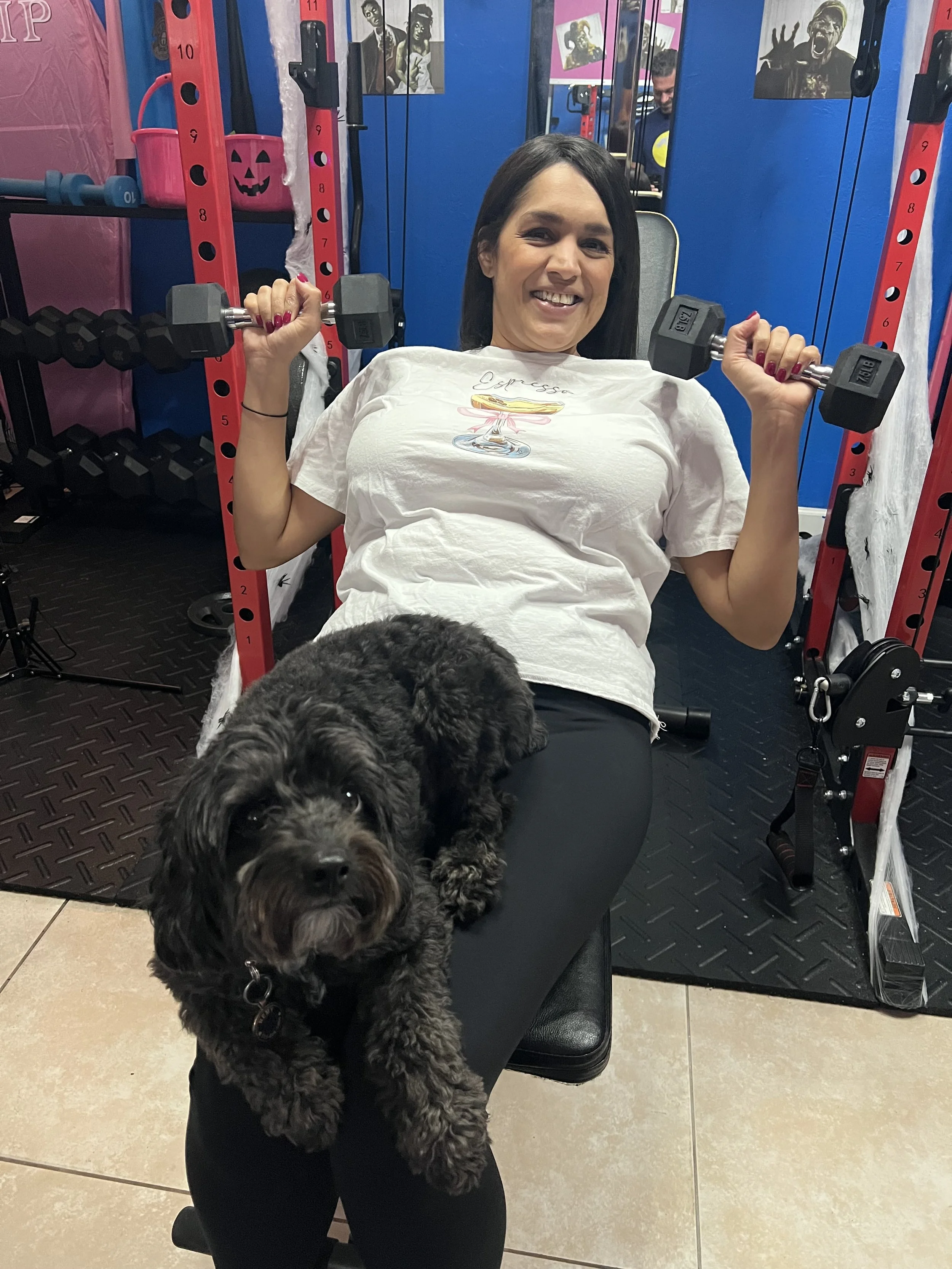 Remy cheering on a client during her chest presses.