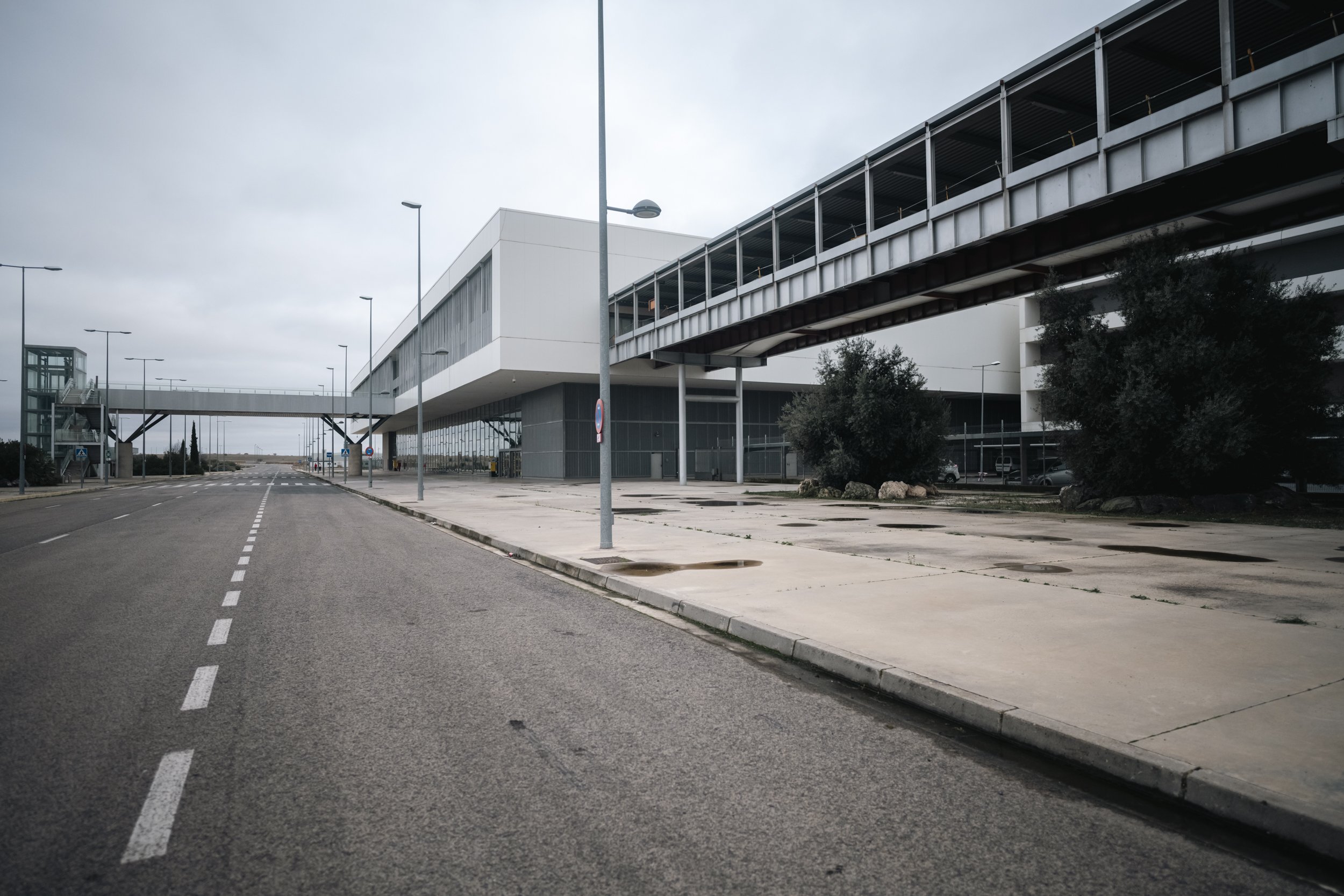 The terminal holds its posture in winter light, a grand entrance with no audience.