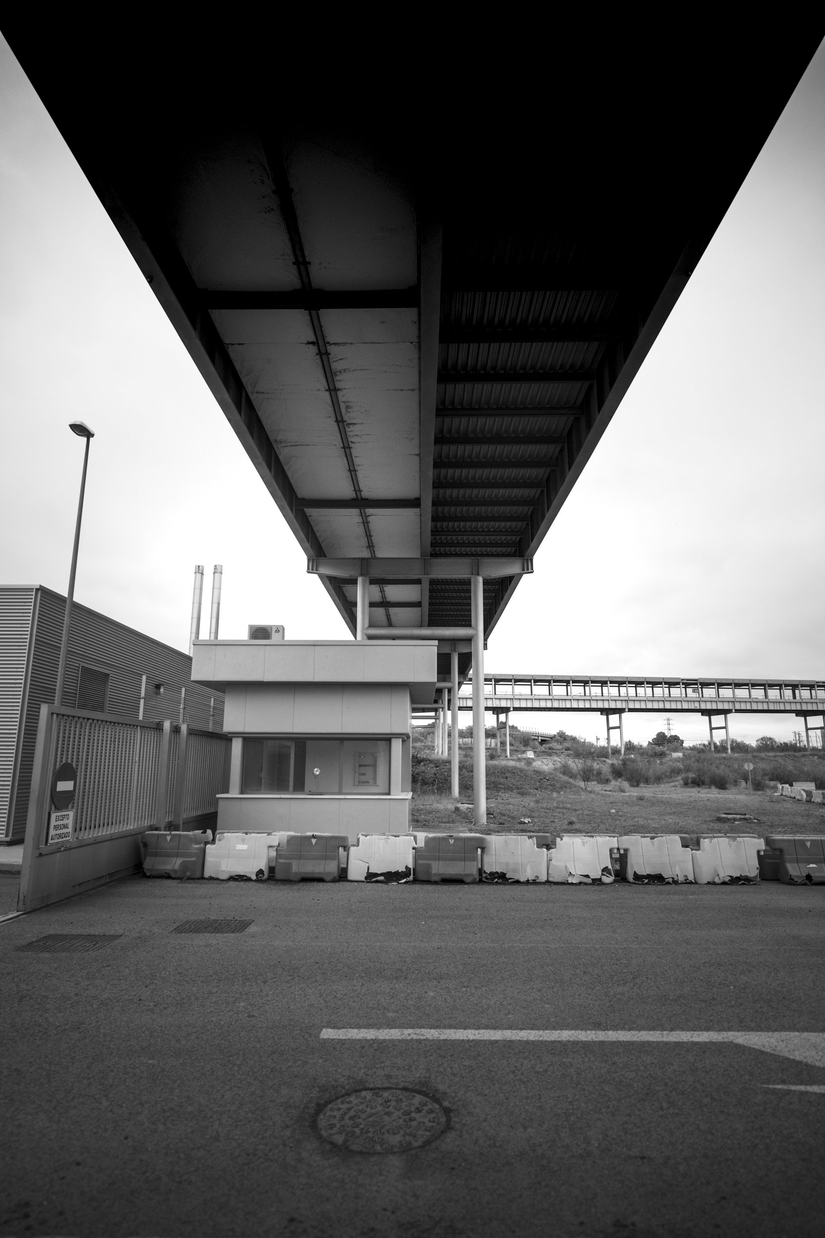 Steel canopy and concrete geometry—monumental, unmoving, unclaimed.