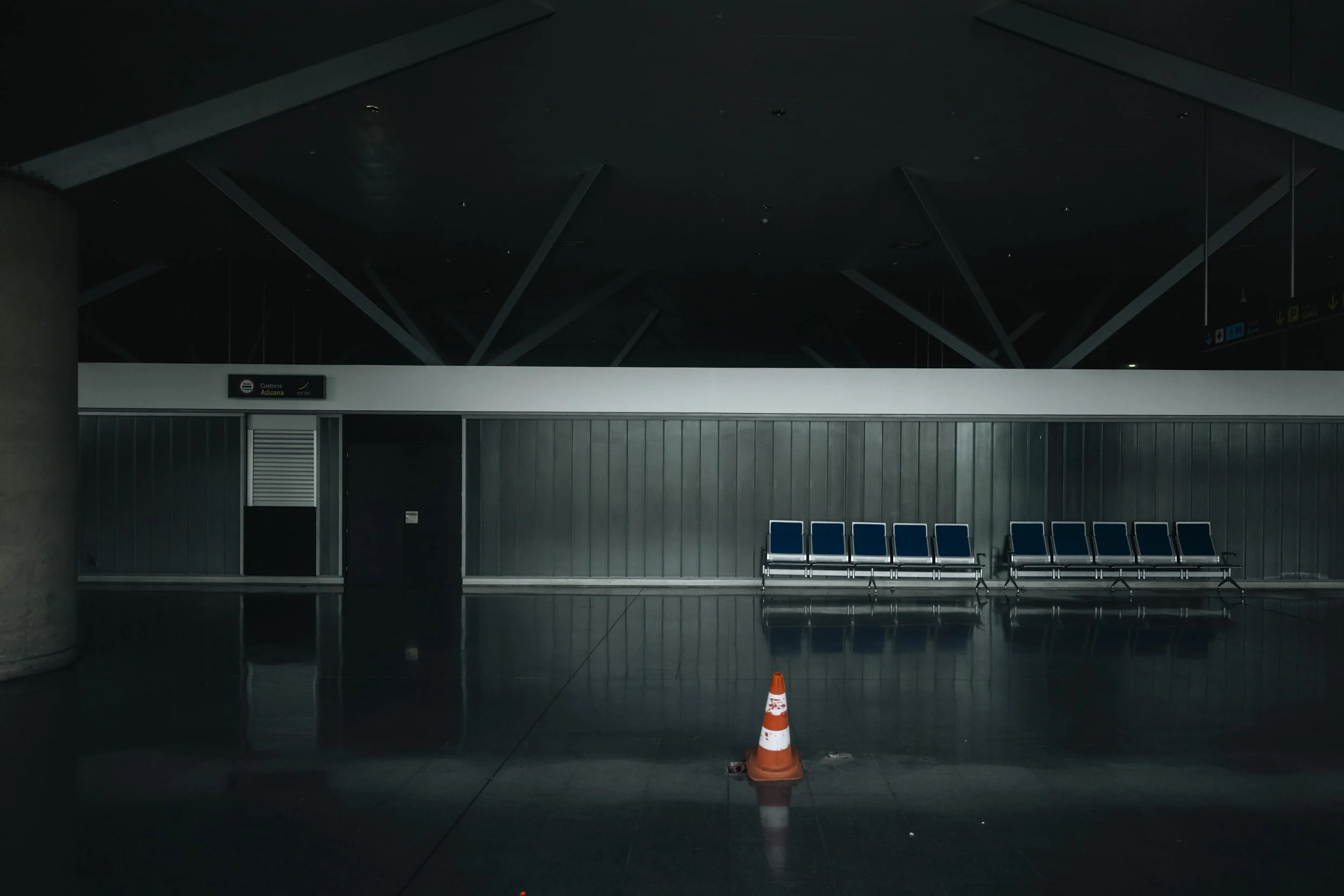 Rows of seats and a single cone—order left behind in an empty hall.