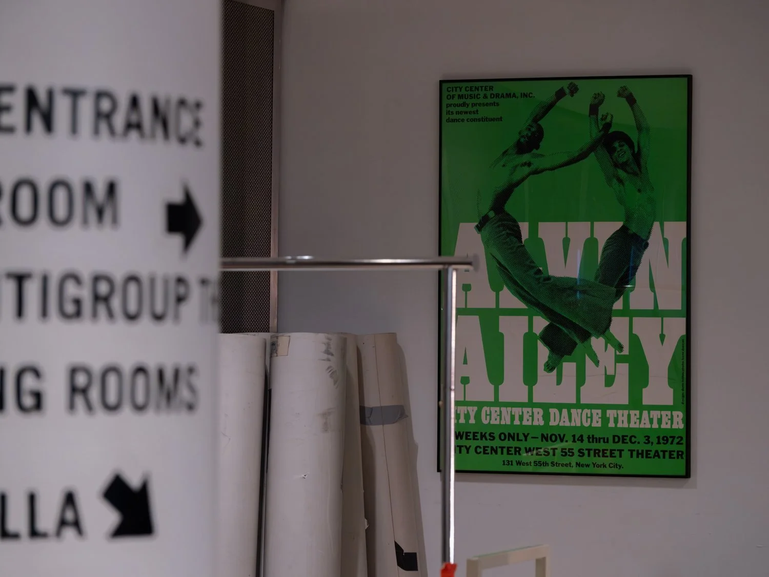 A dance poster in green and black colors featuring two dancers in mid-air poses with arms and legs extended, promoting the Alvin Ailey dance theater performance at City Center, New York City, from November 14 to December 3, 1972.