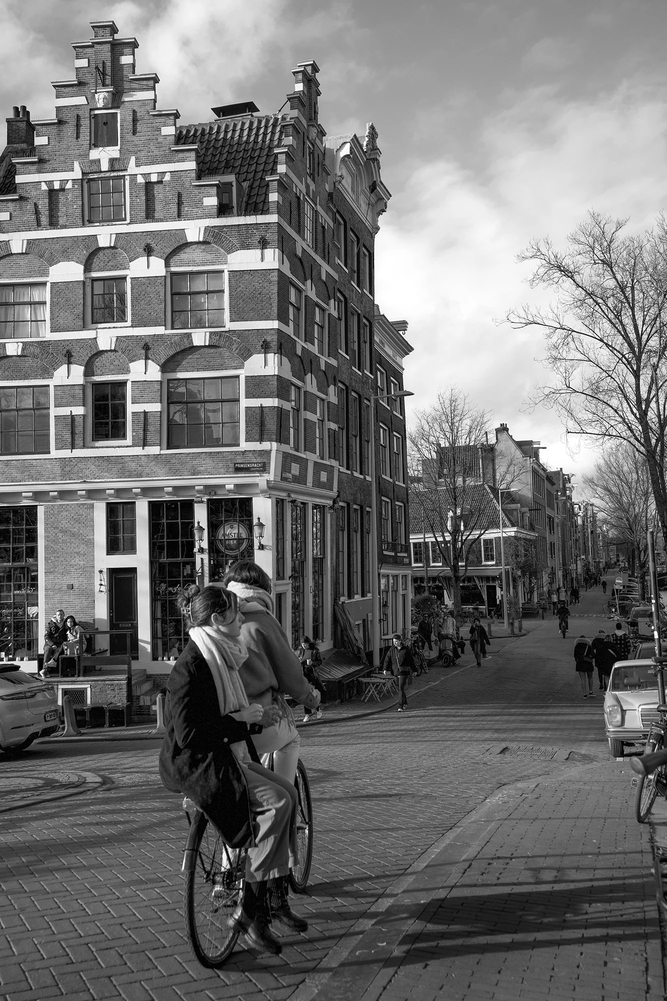 Two friends commuting on bicycle in Amsterdam