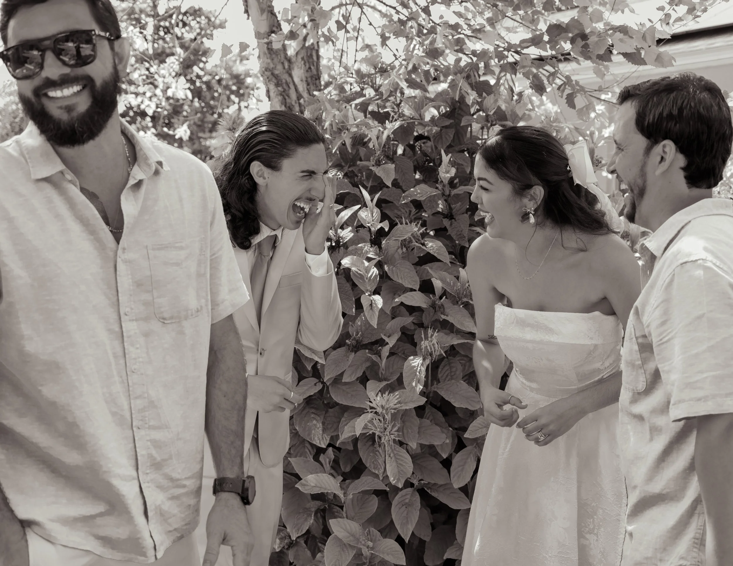 Newly weds sharing a laugh with family
