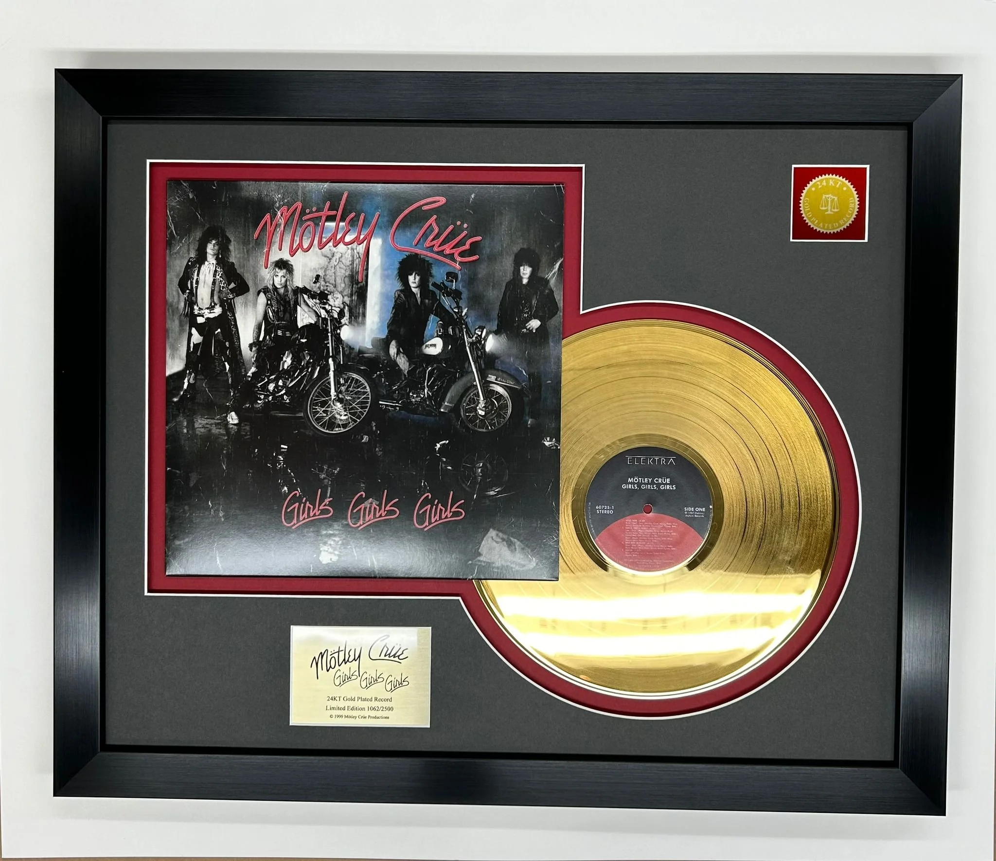 Framed limited edition 24K gold record for Mötley Crüe's album "Girls, Girls, Girls," featuring the album cover with band members and a gold record with the label in the center.