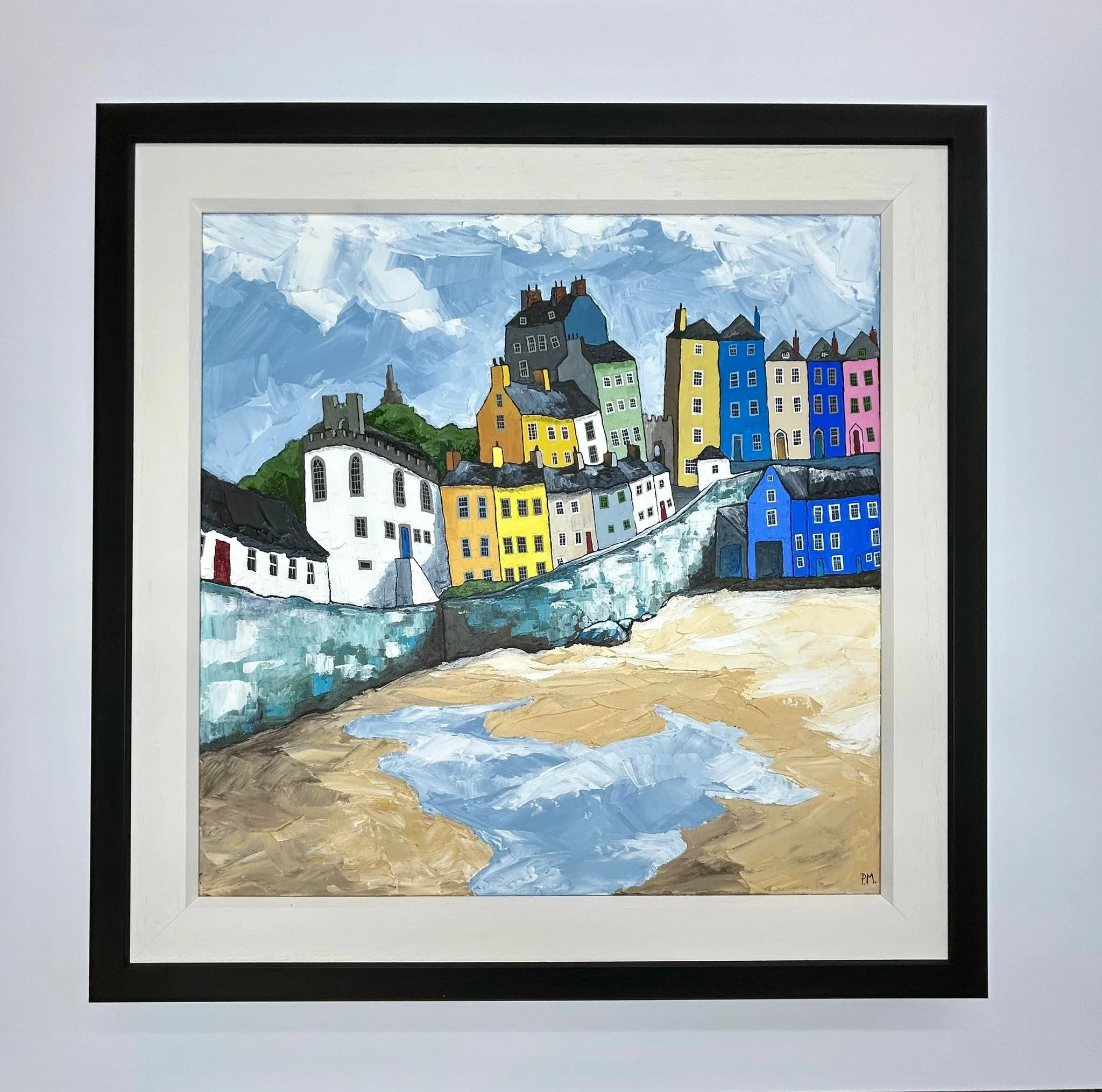 Colorful painting of a seaside village with houses on a hill, a stone wall, and a beach with water, under a cloudy sky.