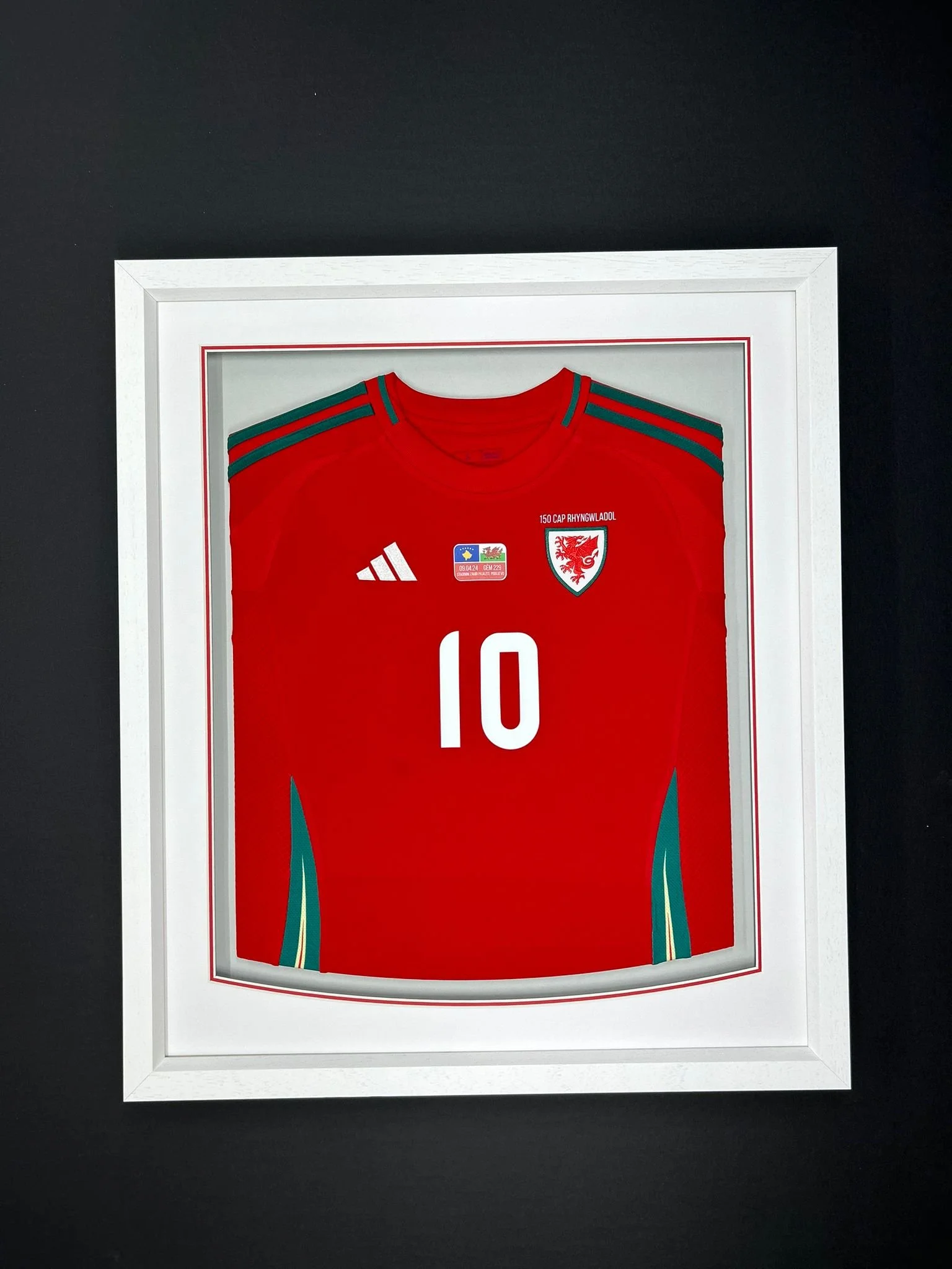 Red football jersey with the number 10, Wales national team badge, and Adidas logo, displayed in a white frame.