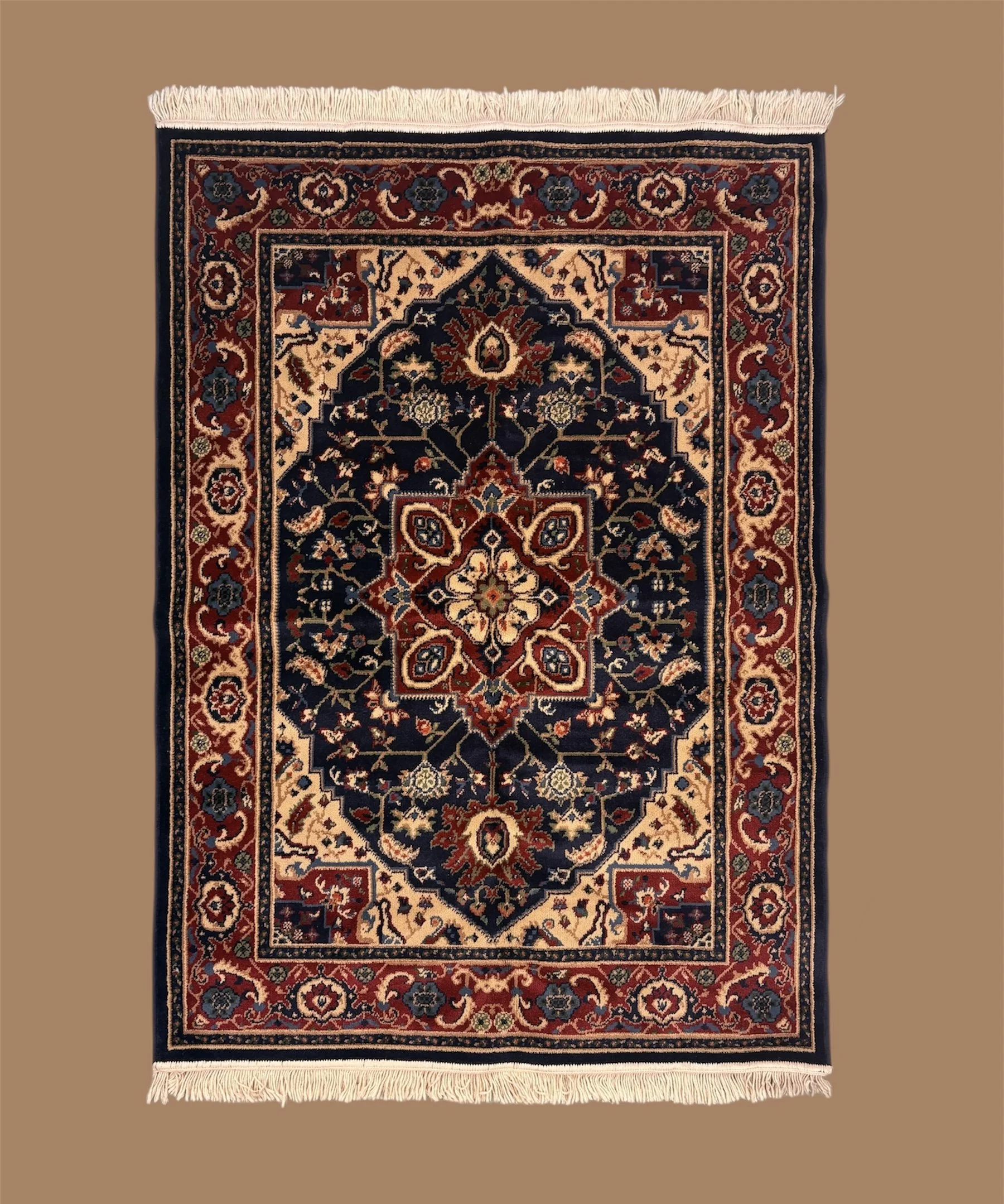 A traditional Persian-style rug with intricate floral patterns in red, navy blue, beige, and light blue, featuring a central medallion and fringed edges.