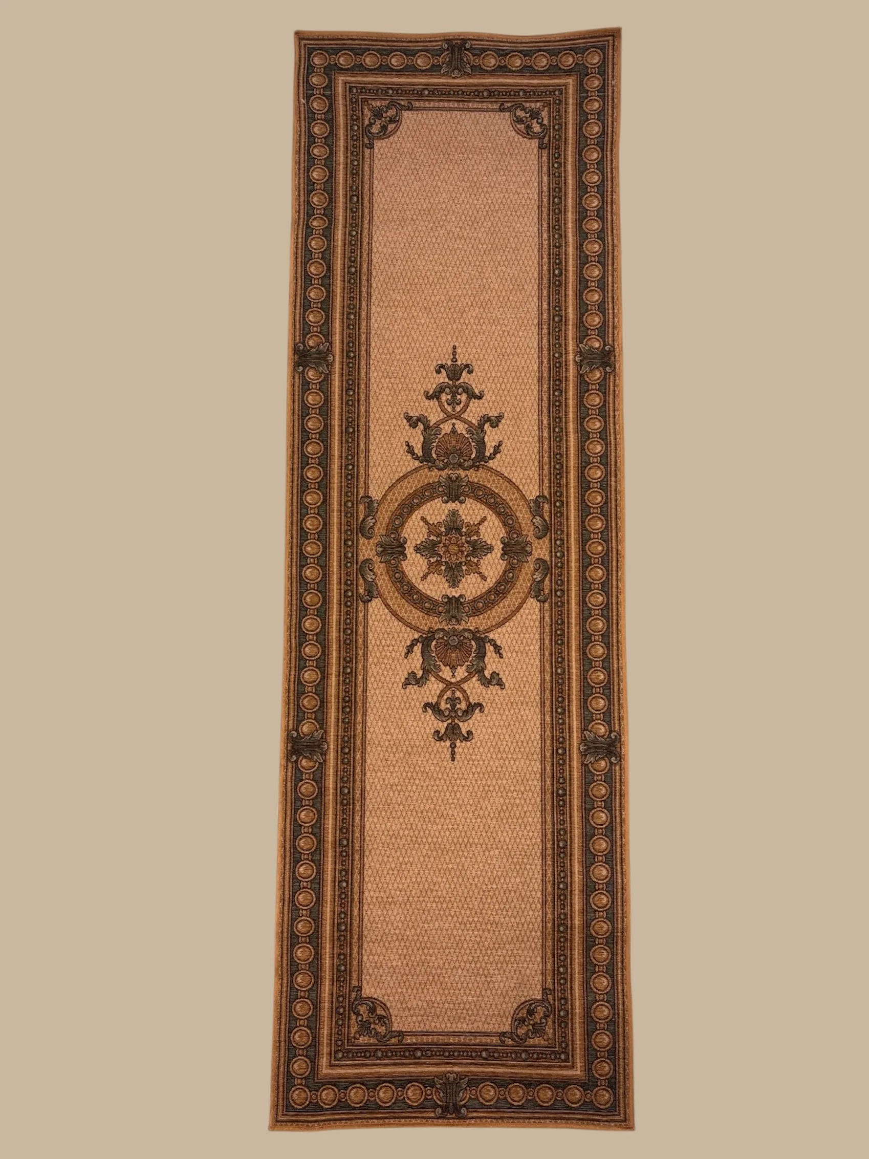 A long, ornate rectangular area rug with a central floral medallion, intricate border patterns, and a warm color palette of browns and tans.