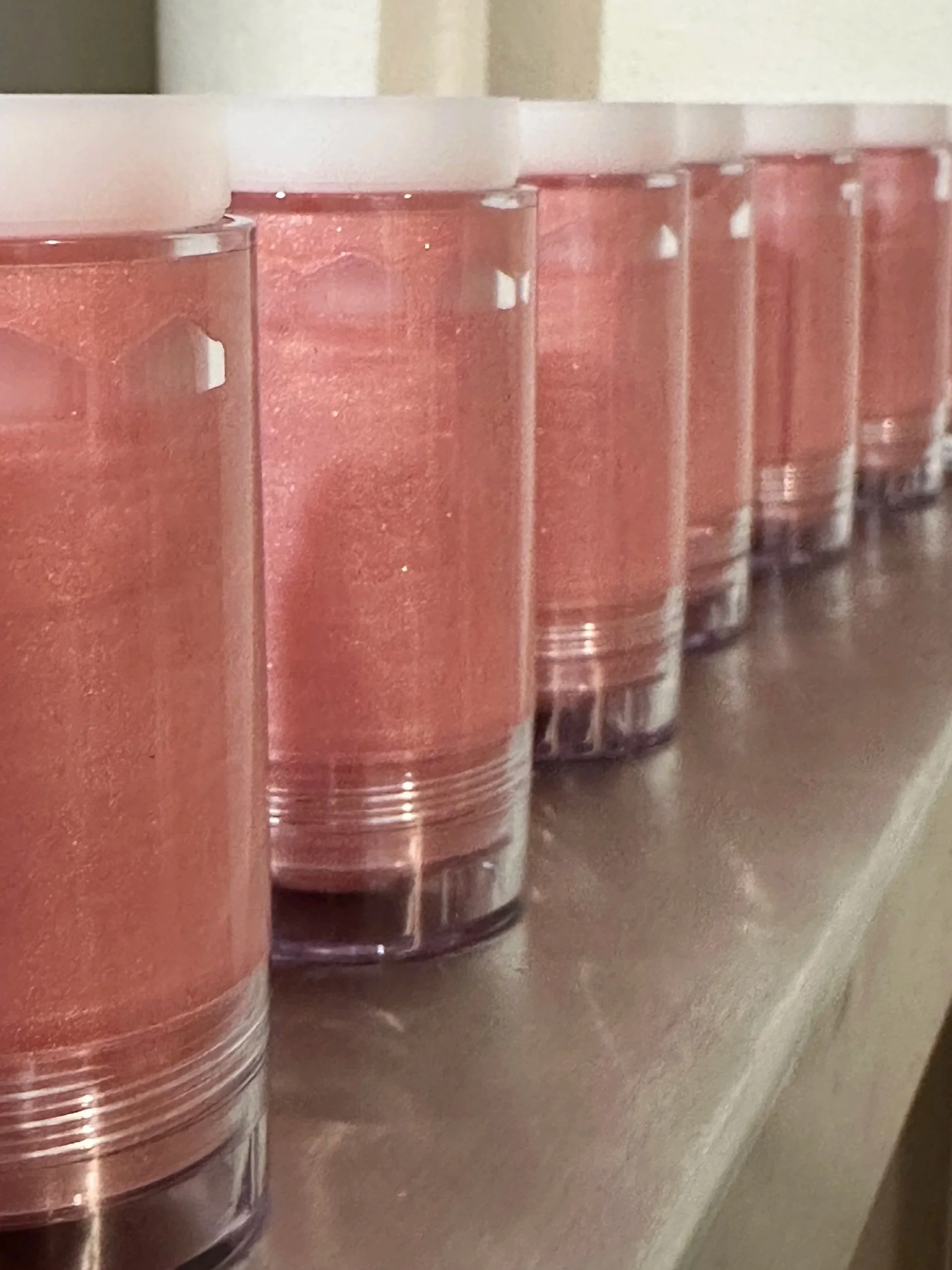 Shimmer Glow Sticks in Sunkissed curing in easy to use twist up sticks! These are upside down, the final product has a lovely smooth rounded top.