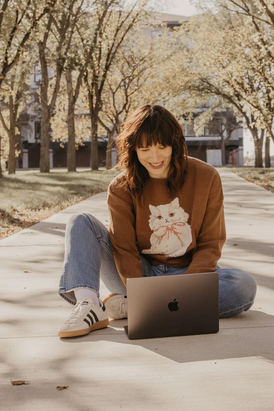 Close-up of a butterfly's wing displaying intricate patterns in brown, orange, tan, cream, and white colors.