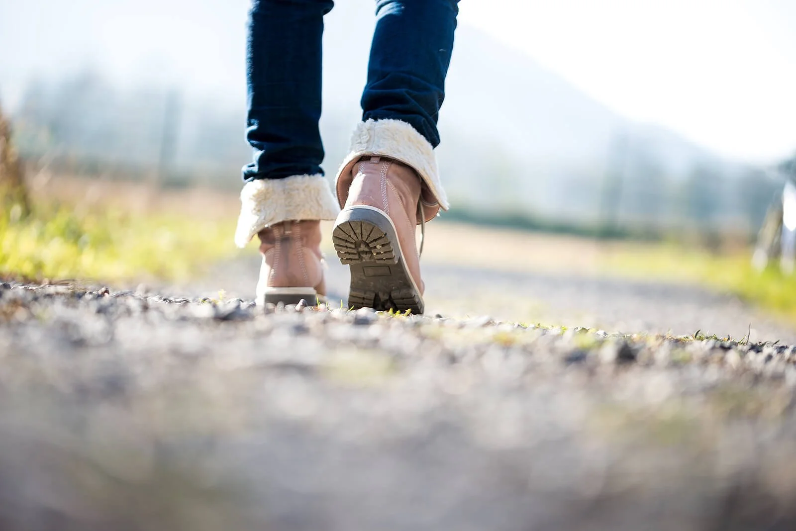 A close-up of someone walking outdoors on a quiet path, suggesting steady progress and nervous system grounding. It pairs well with ocd therapy for young adults, support from an ocd therapist in provo, ut