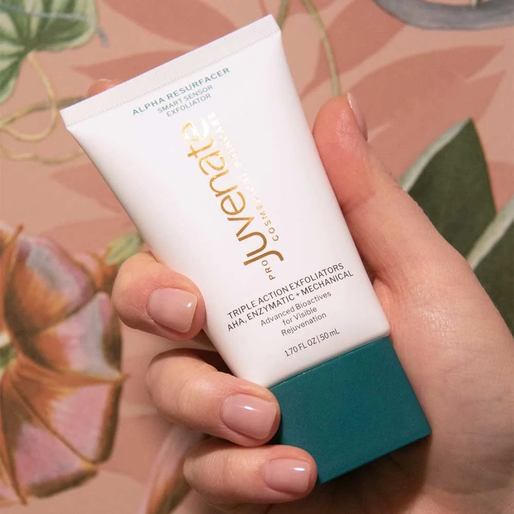 close up of hand holding Juvenate Alpha Resurfacer