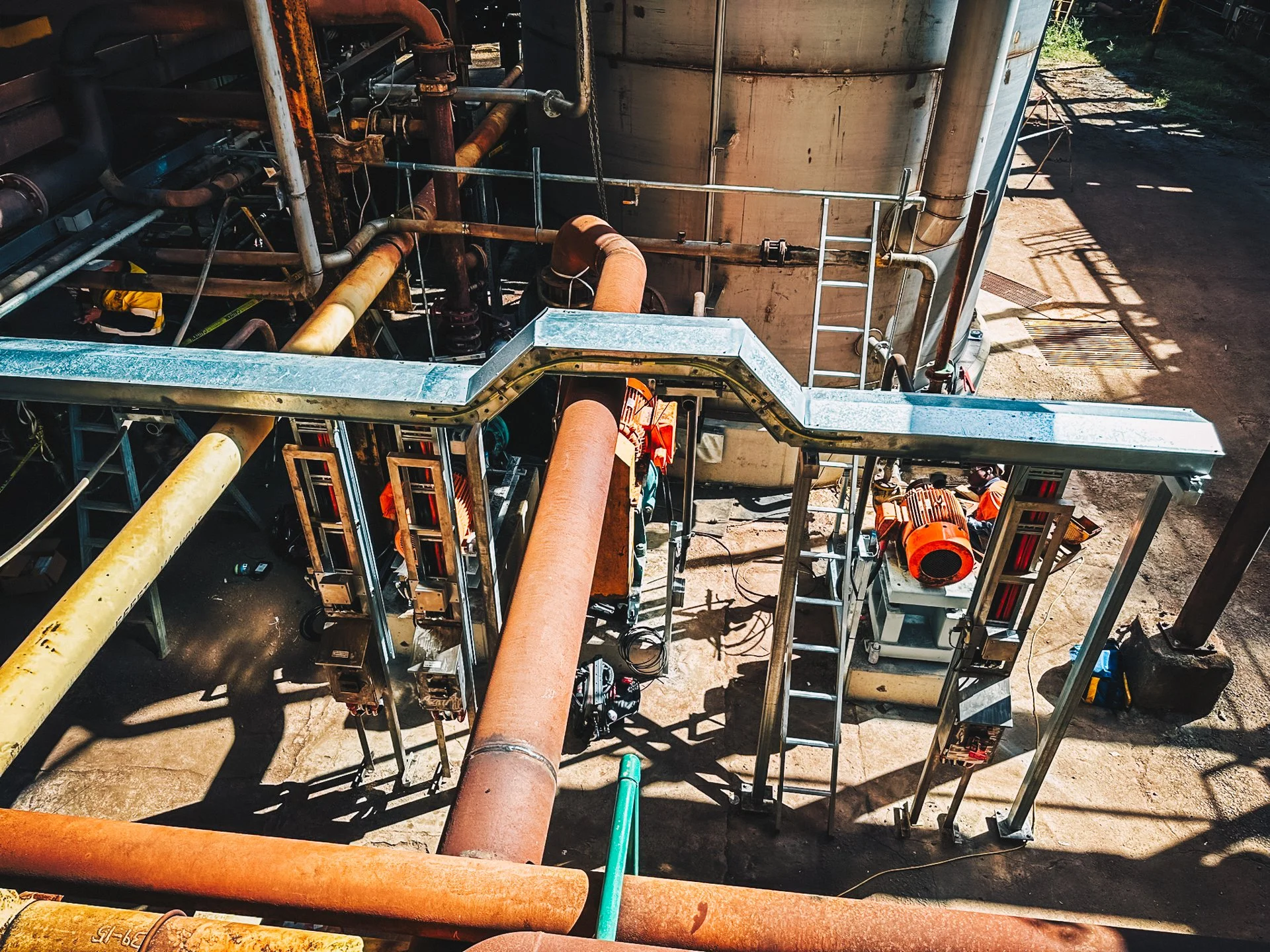 yellow and orange rusting piping's in an industrial area