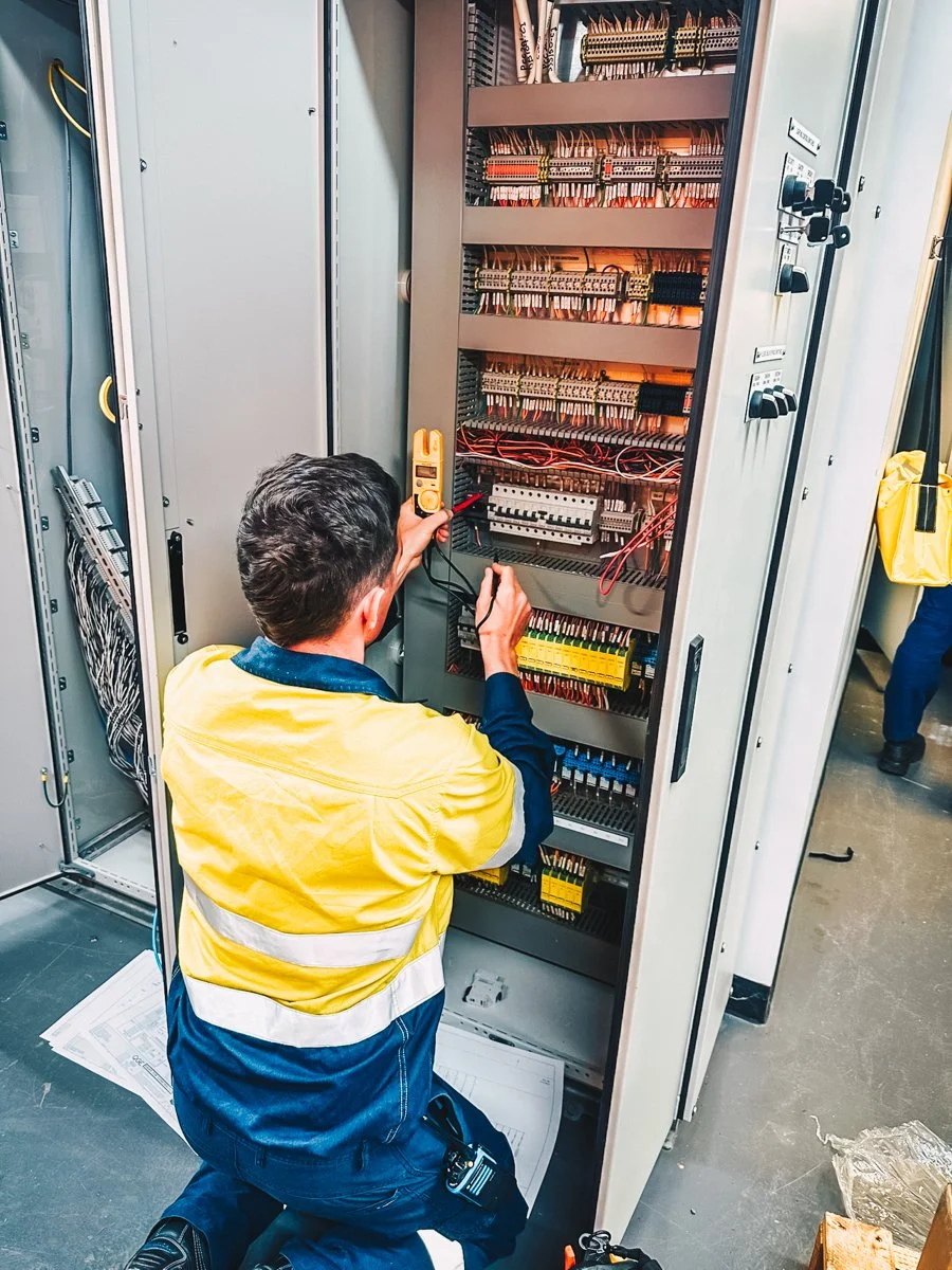 Dave Griffith Electrical worker looking at an old electrical board and diagnostic testing