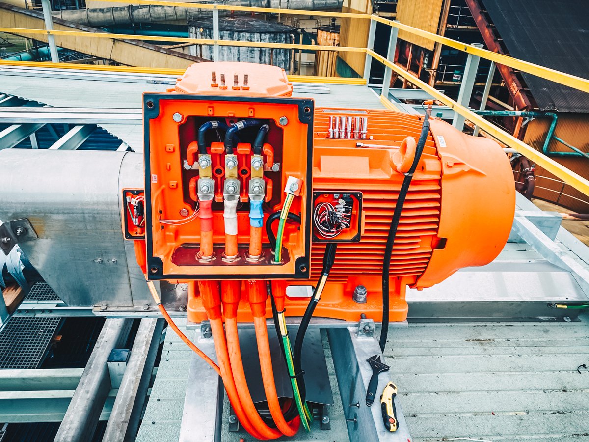 orange motor with electrical wires inside