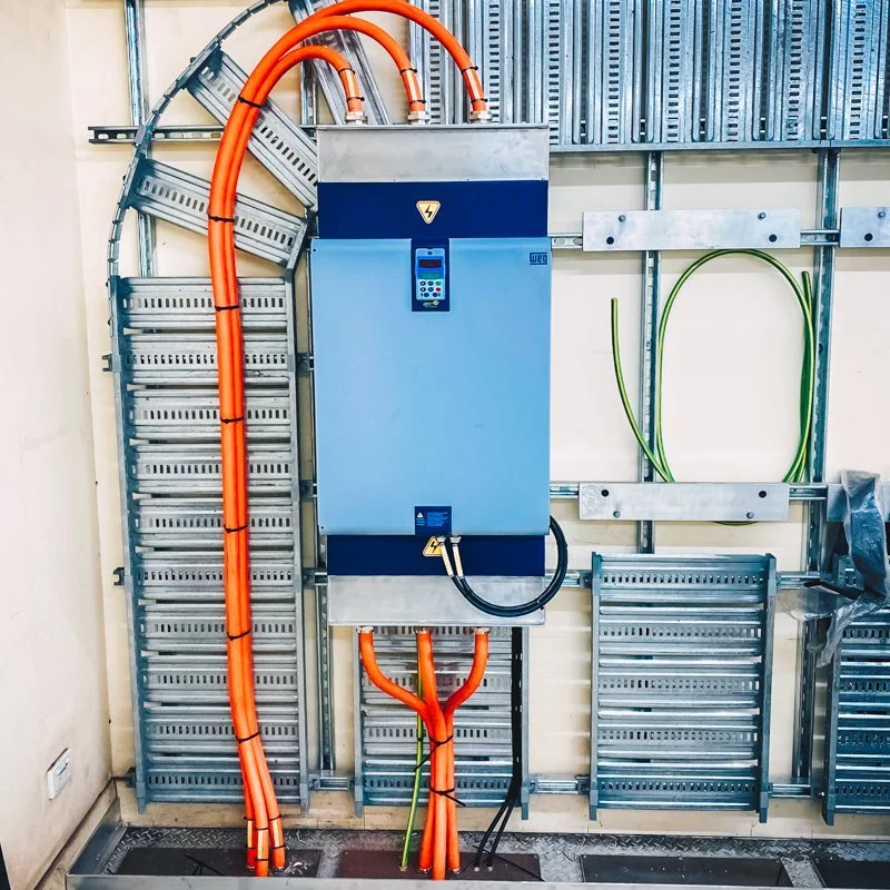 massive control panel that has industrial conduit coming out of it 