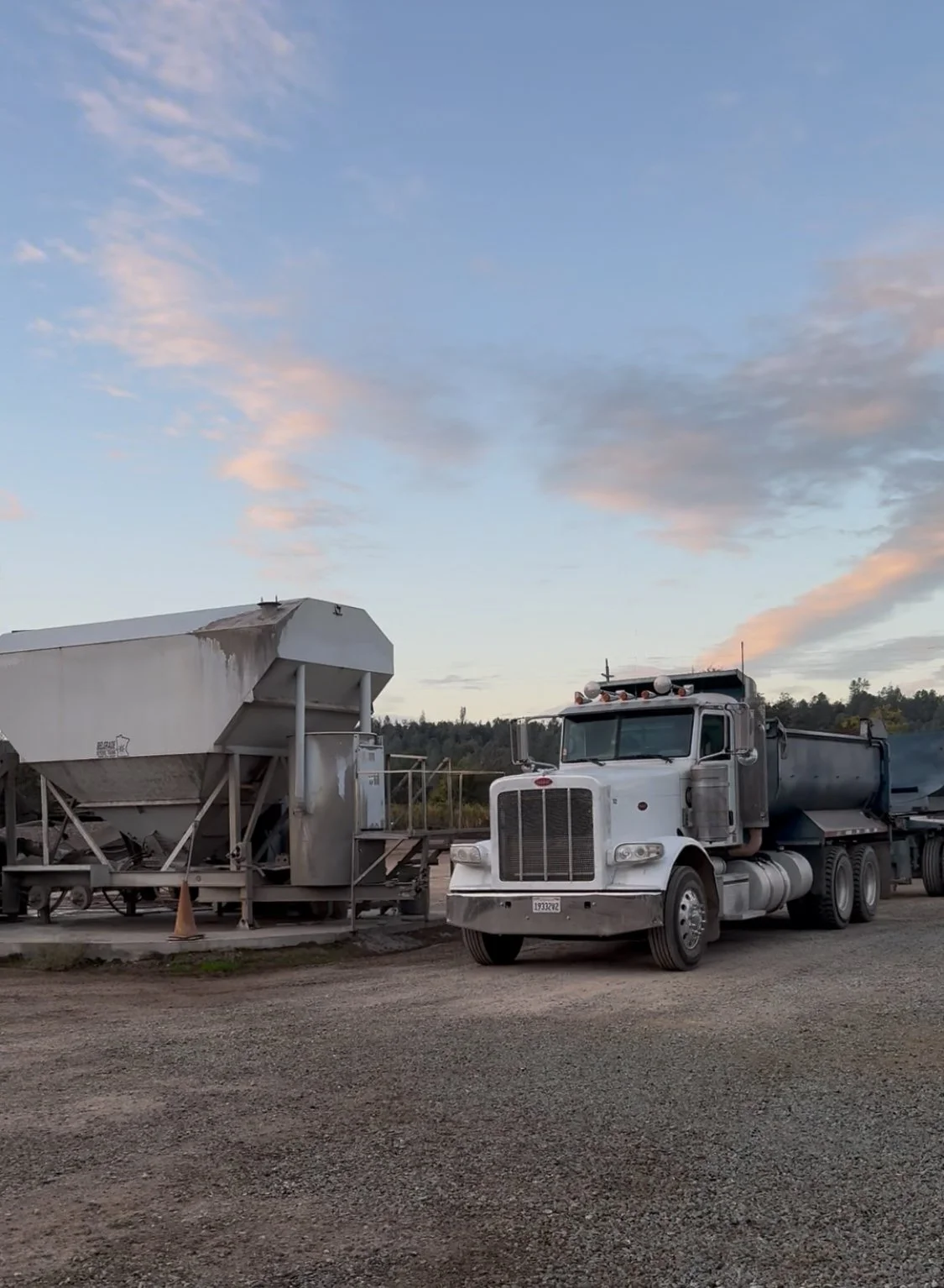 Large white cement mixer truck at Wild Toad Landscape Materials on a gravel lot serving concrete needs in Anderson, Redding, Cottonwood, and surrounding areas.