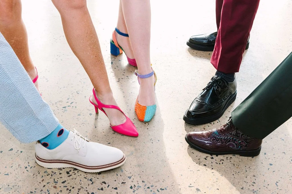 Photo of five sets of colorful shoes in a circle, pointed in, image for a friendship ceremony