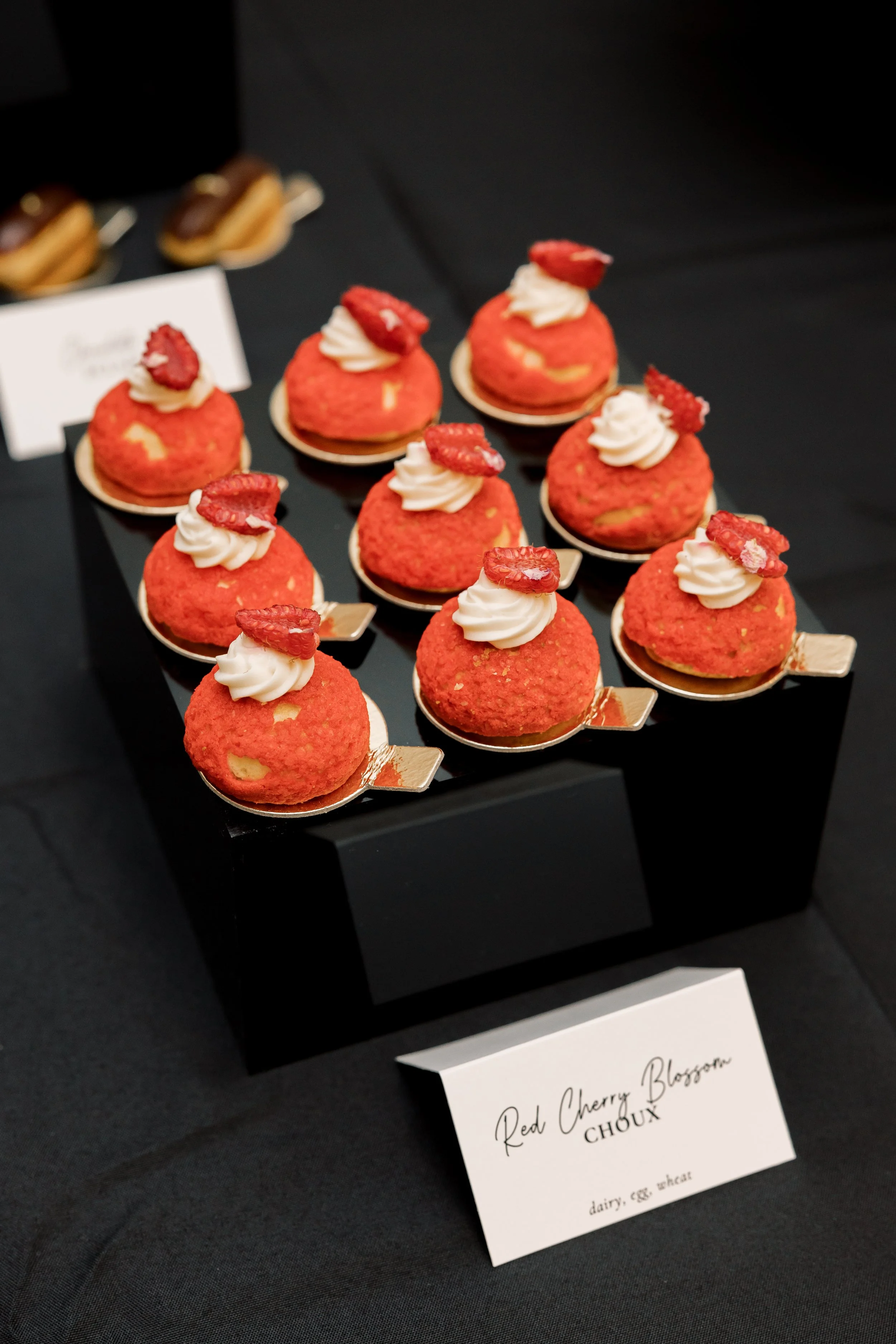 Cherry blossom puff pastries on a black tablecloth