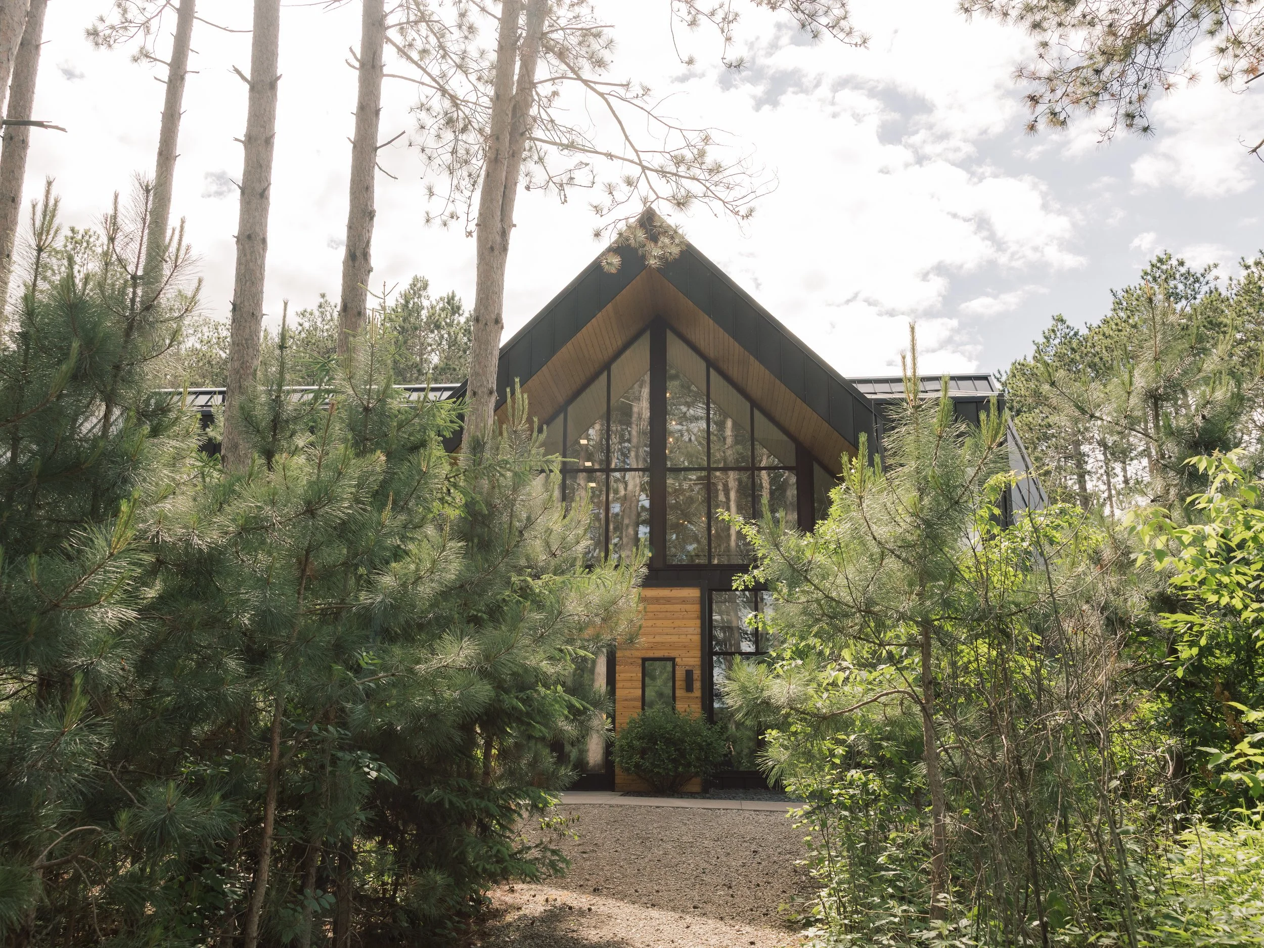 Black and wood event venue in the woods