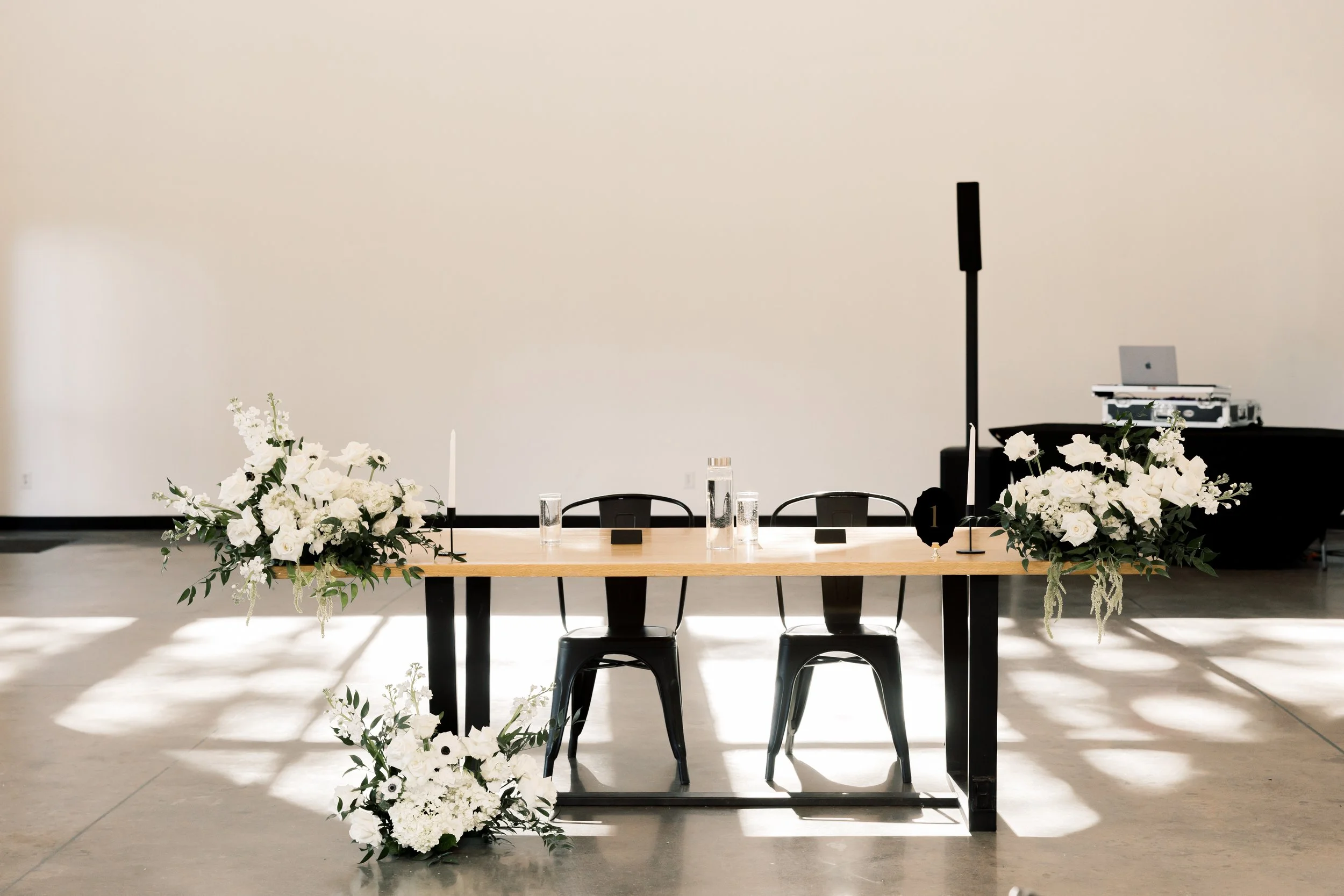 Head table with white floral arrangements
