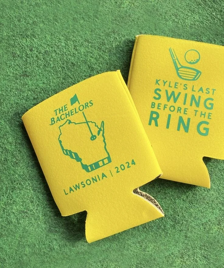 Yellow koozies laying on grass that read "Kyle's last swing before the ring".