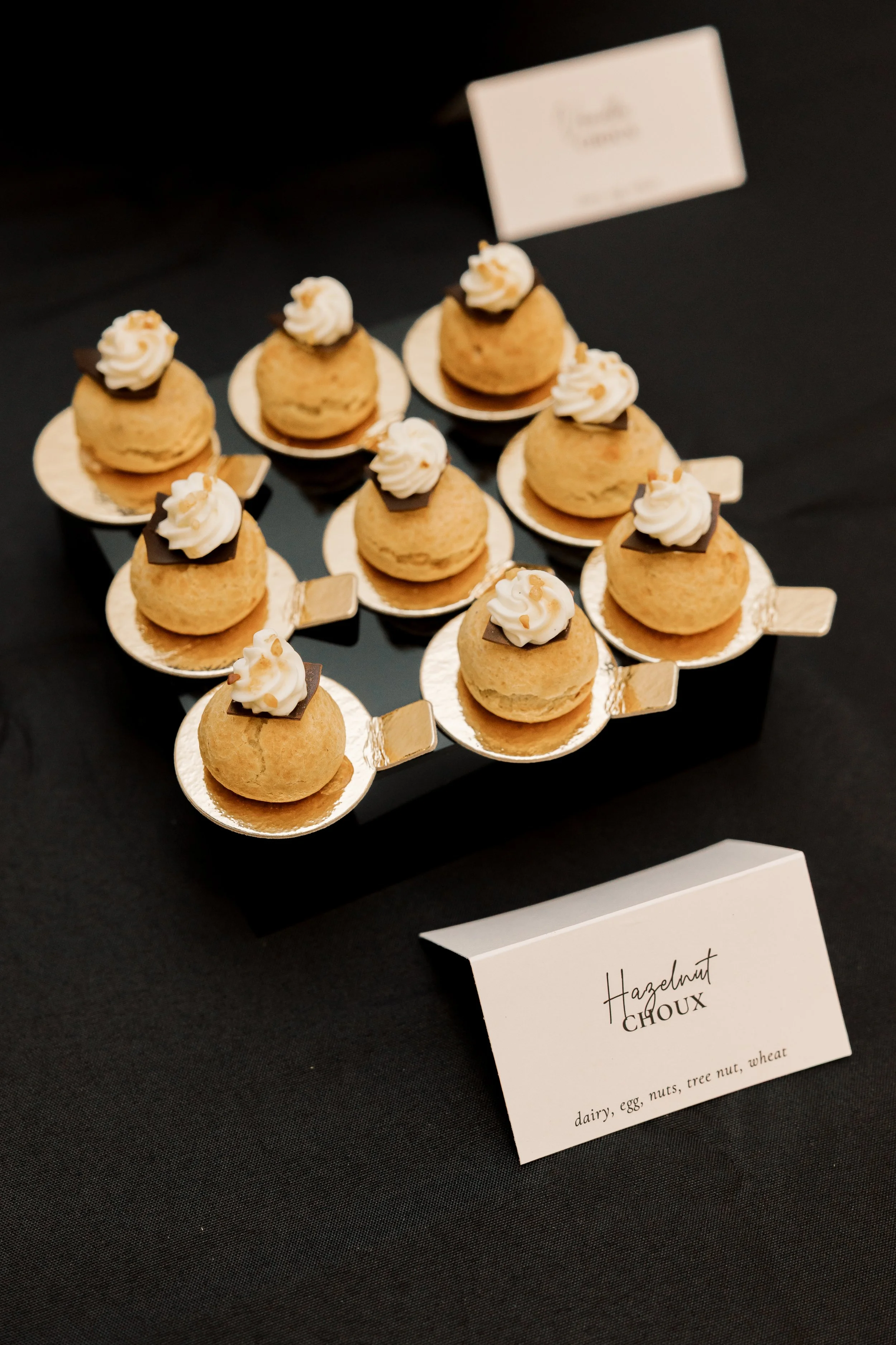 Hazelnut puff pastries on a black tablecloth