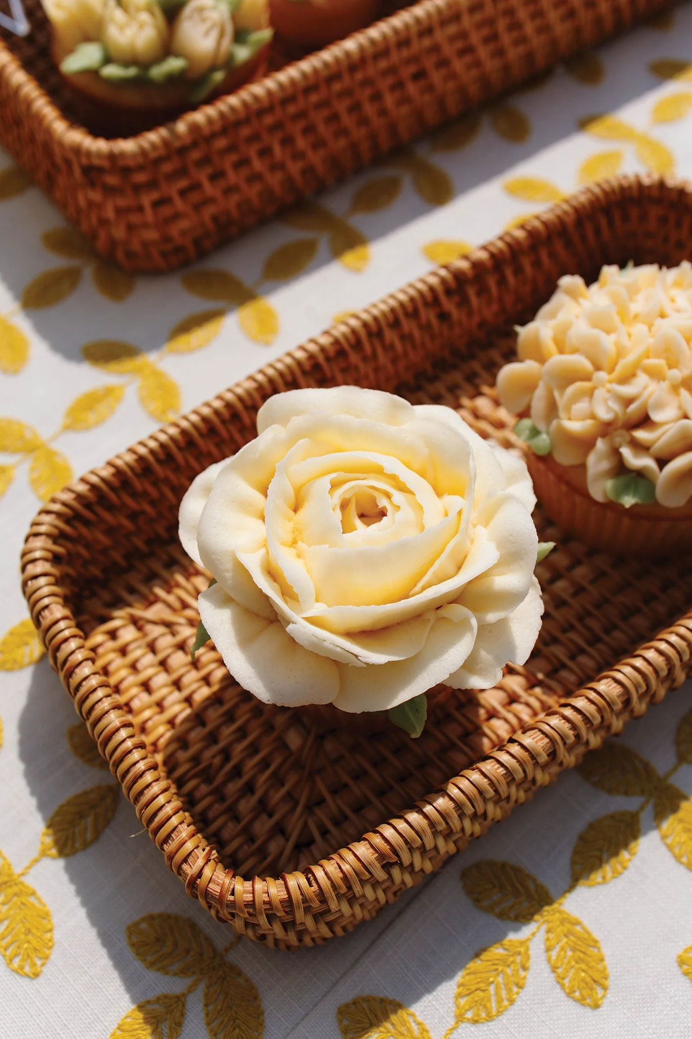 Up close of a yellow floral cupcake