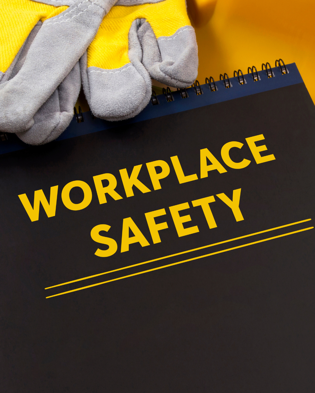 A black clipboard with yellow text reading 'WORKPLACE SAFETY' and yellow lines underneath, placed on a yellow surface, with grey and yellow work gloves on top.