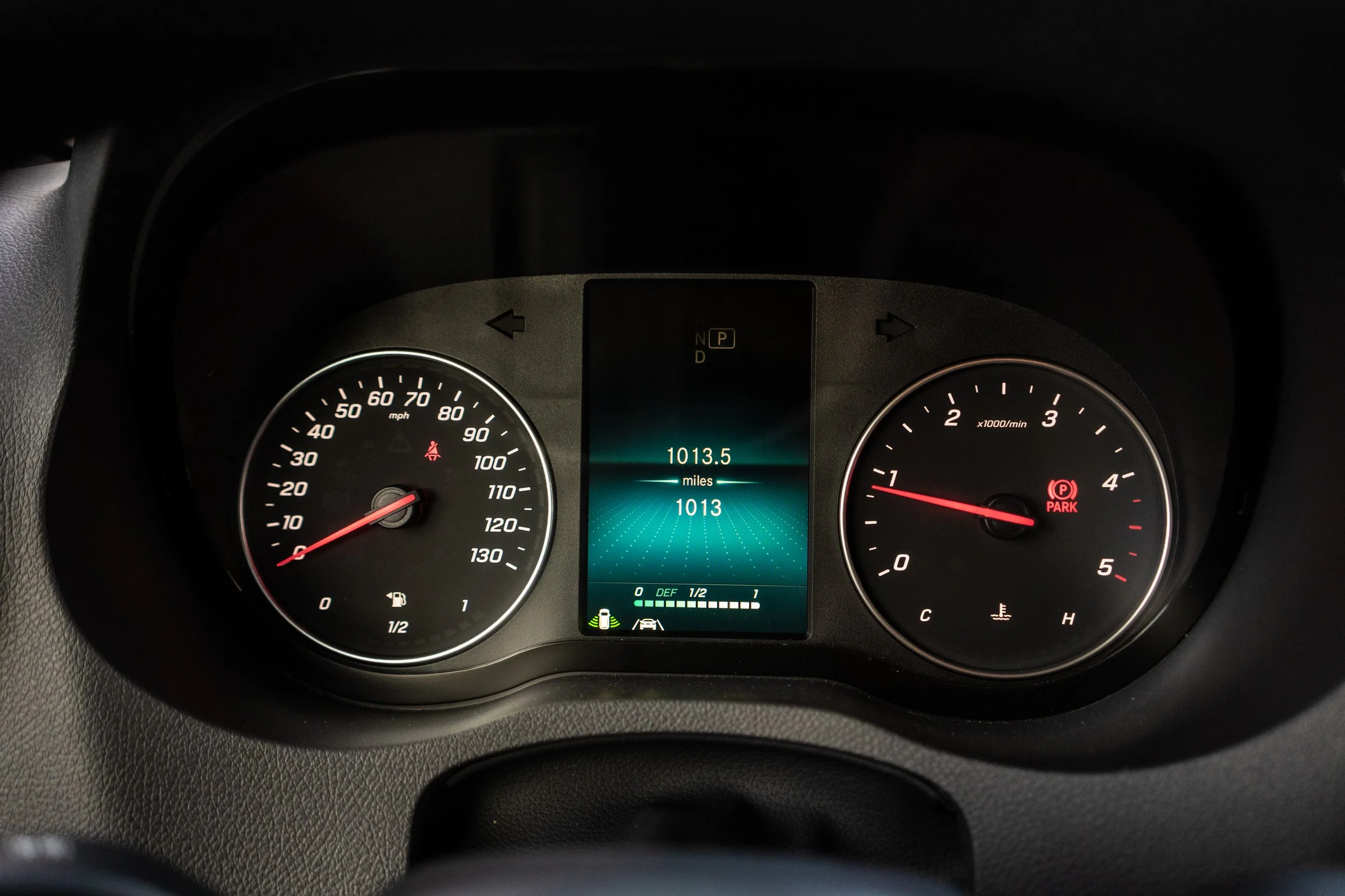 Car dashboard showing speedometer, tachometer, and digital display with mileage and other indicators.